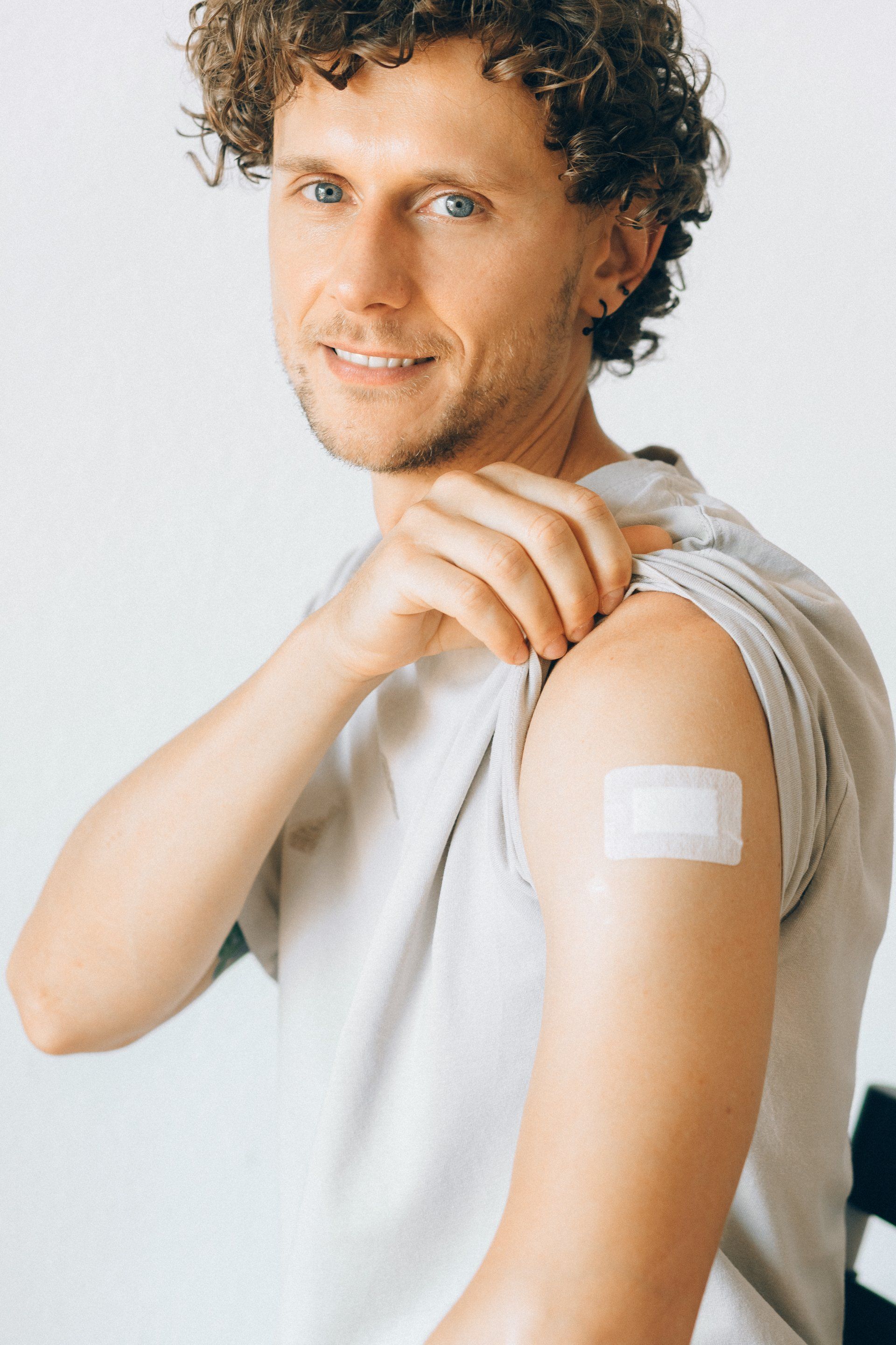 man with uncovered arm ready for vaccination
