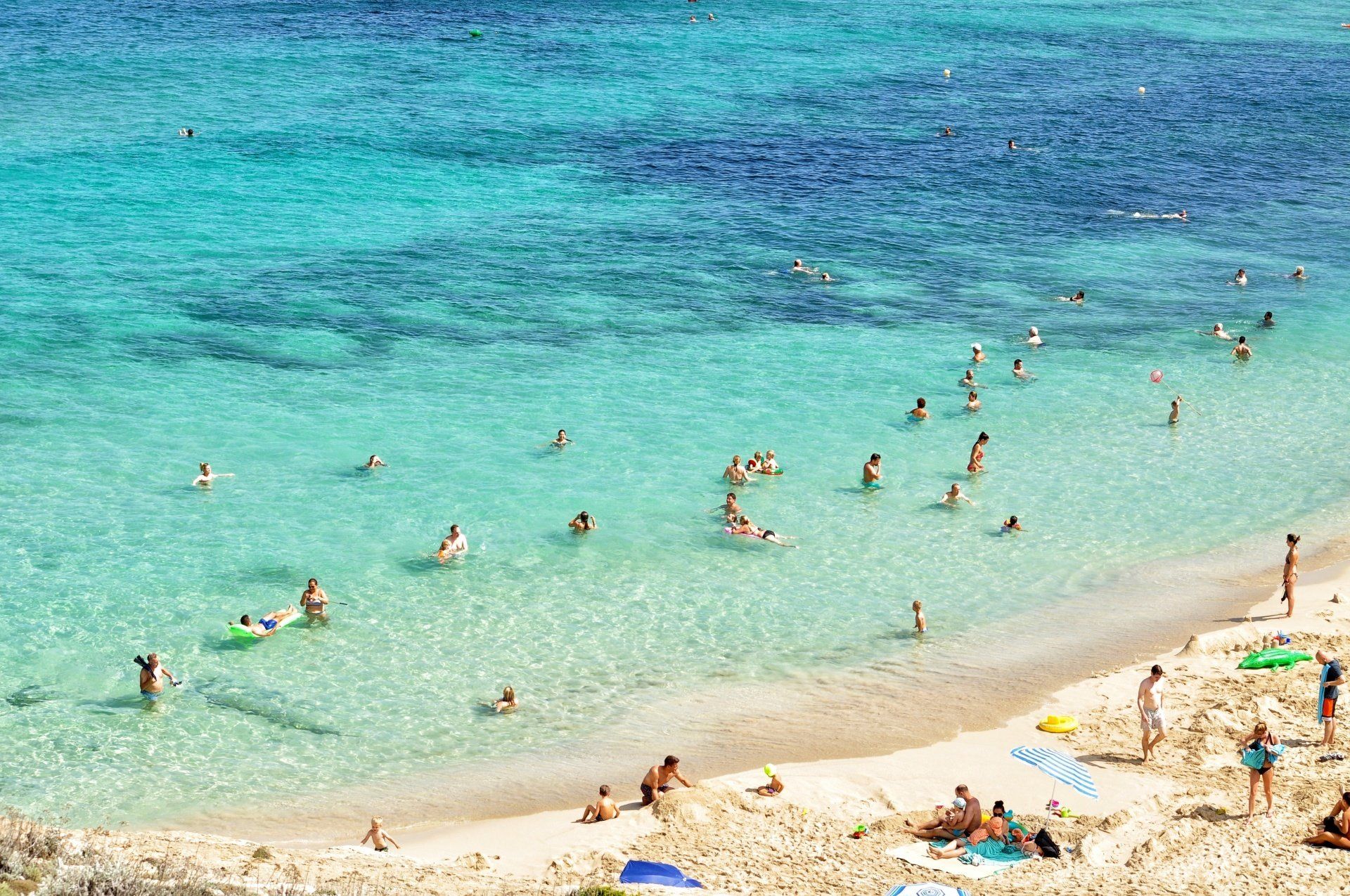 Tourists having fun at a beach in Spain.
