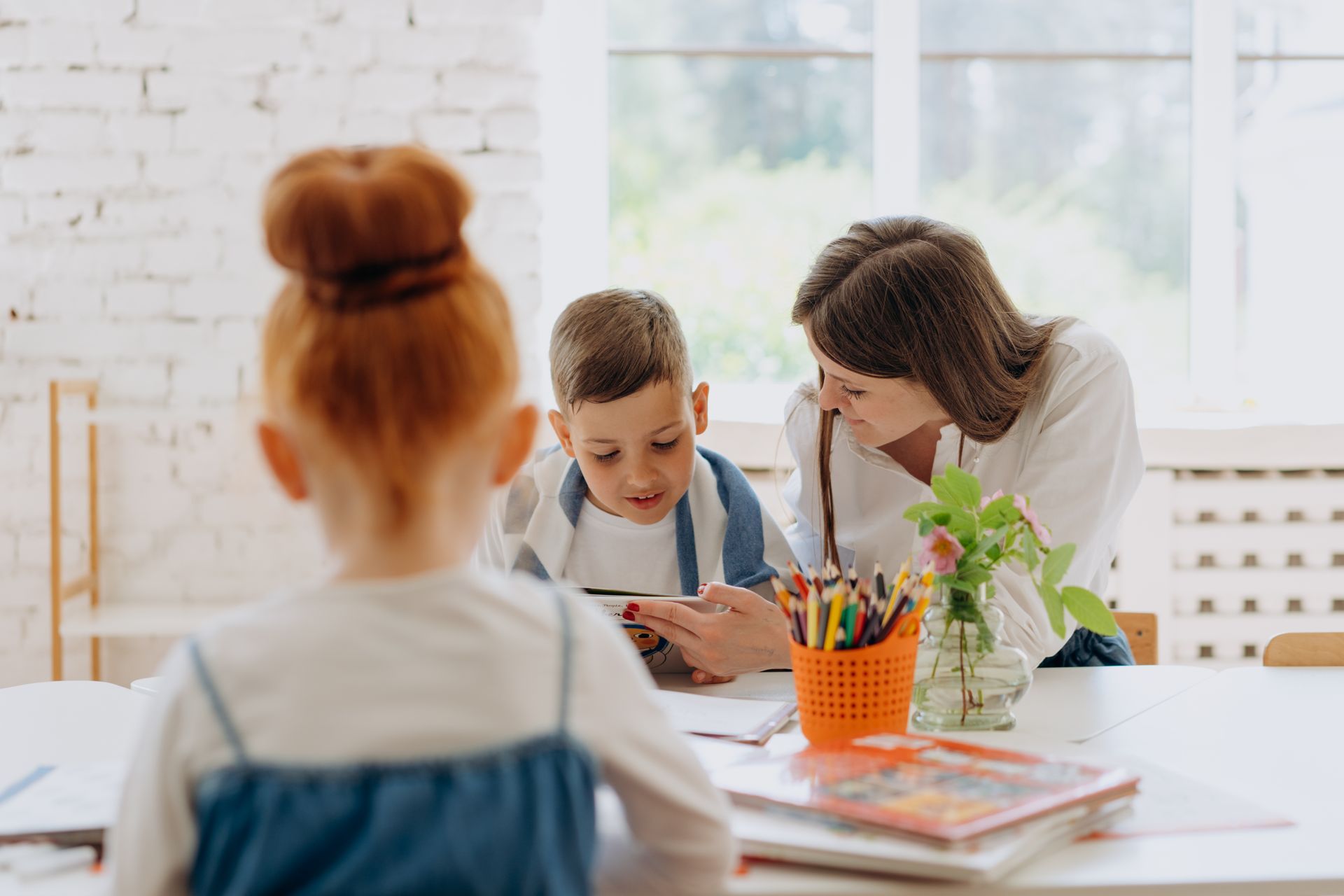 Children and their parent sitting around a table