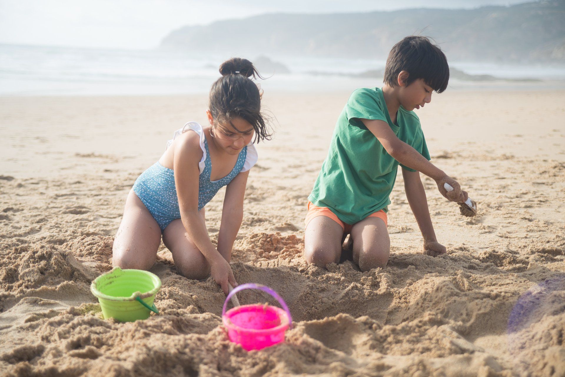 Kids playing on the beach in the summer