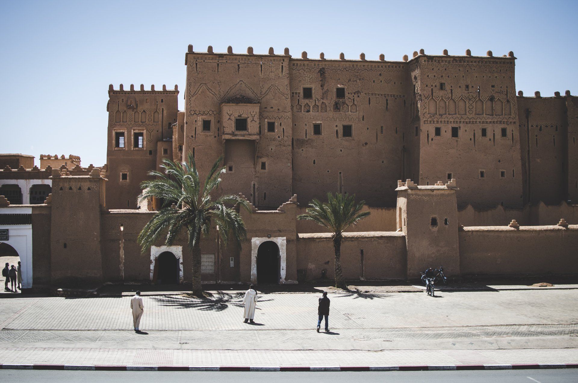 A large building with a palm tree in front of it