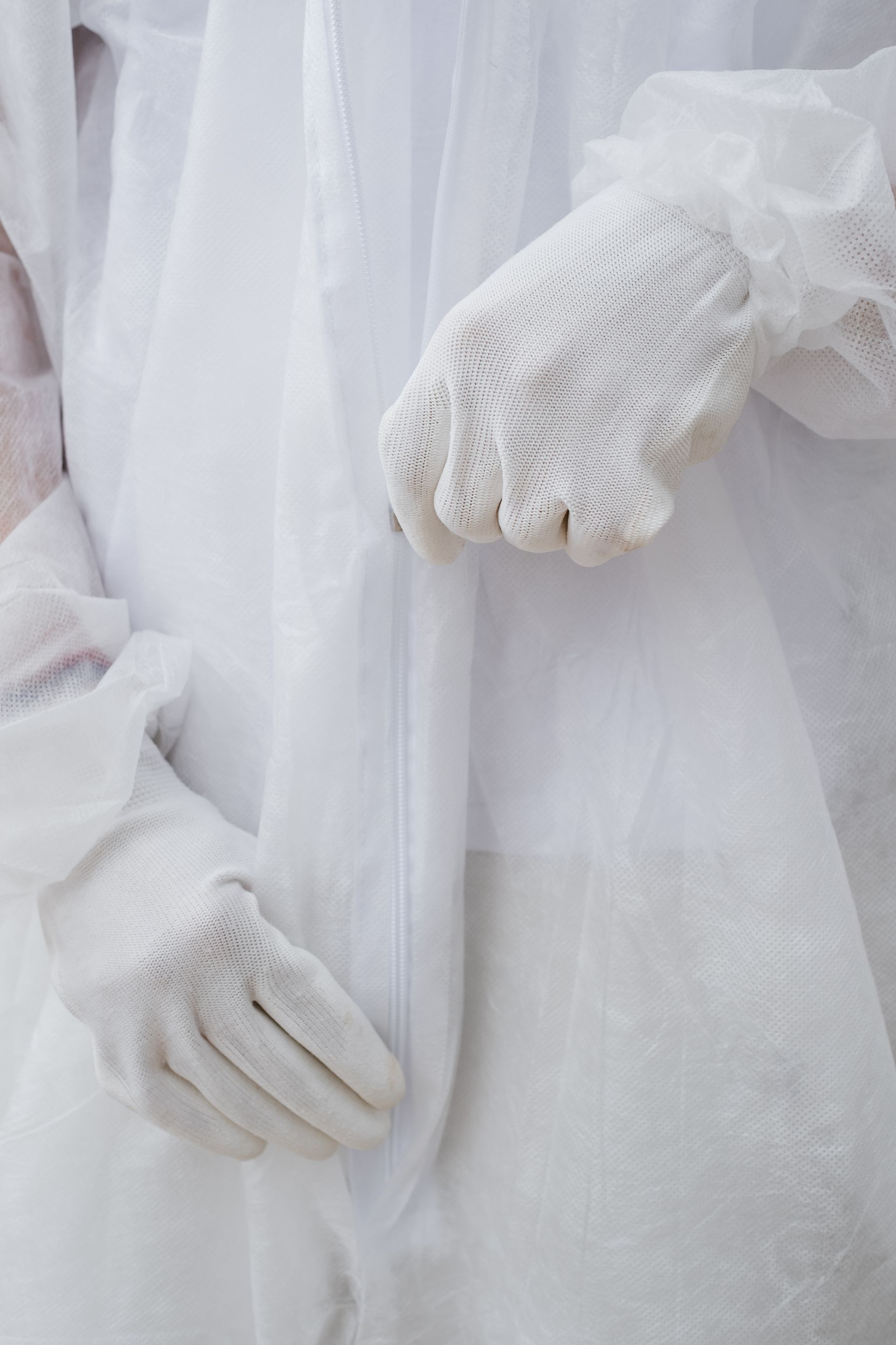 professional restoration team wearing hazmat suits during hazardous material cleanup