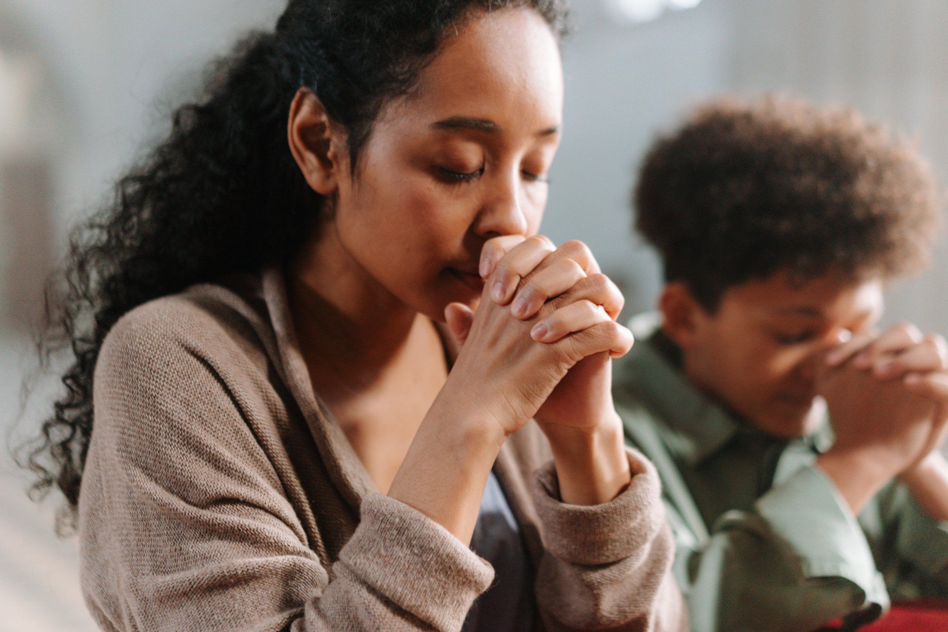 Young black women praying.