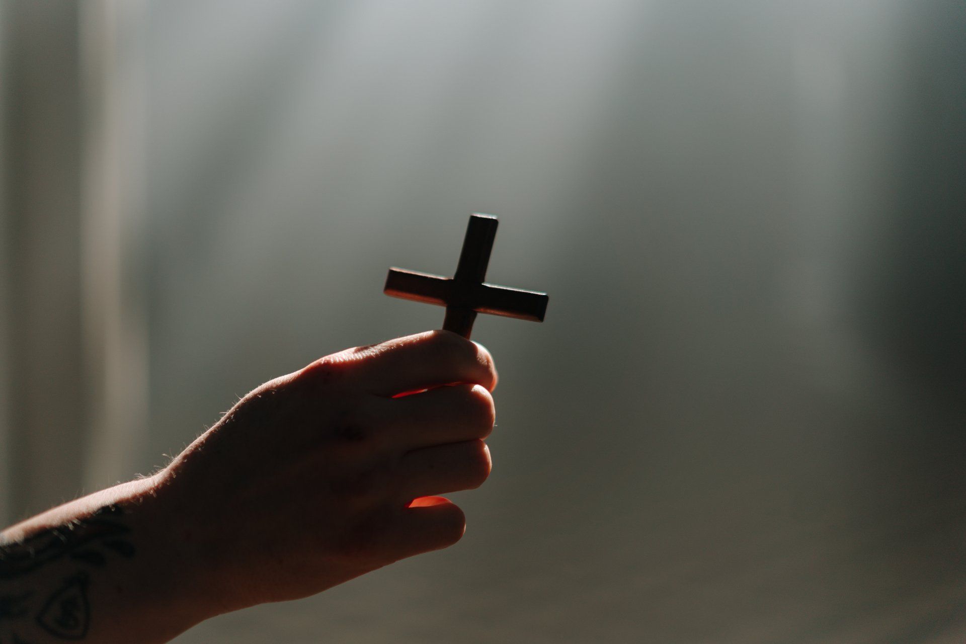 hand holding a small cross