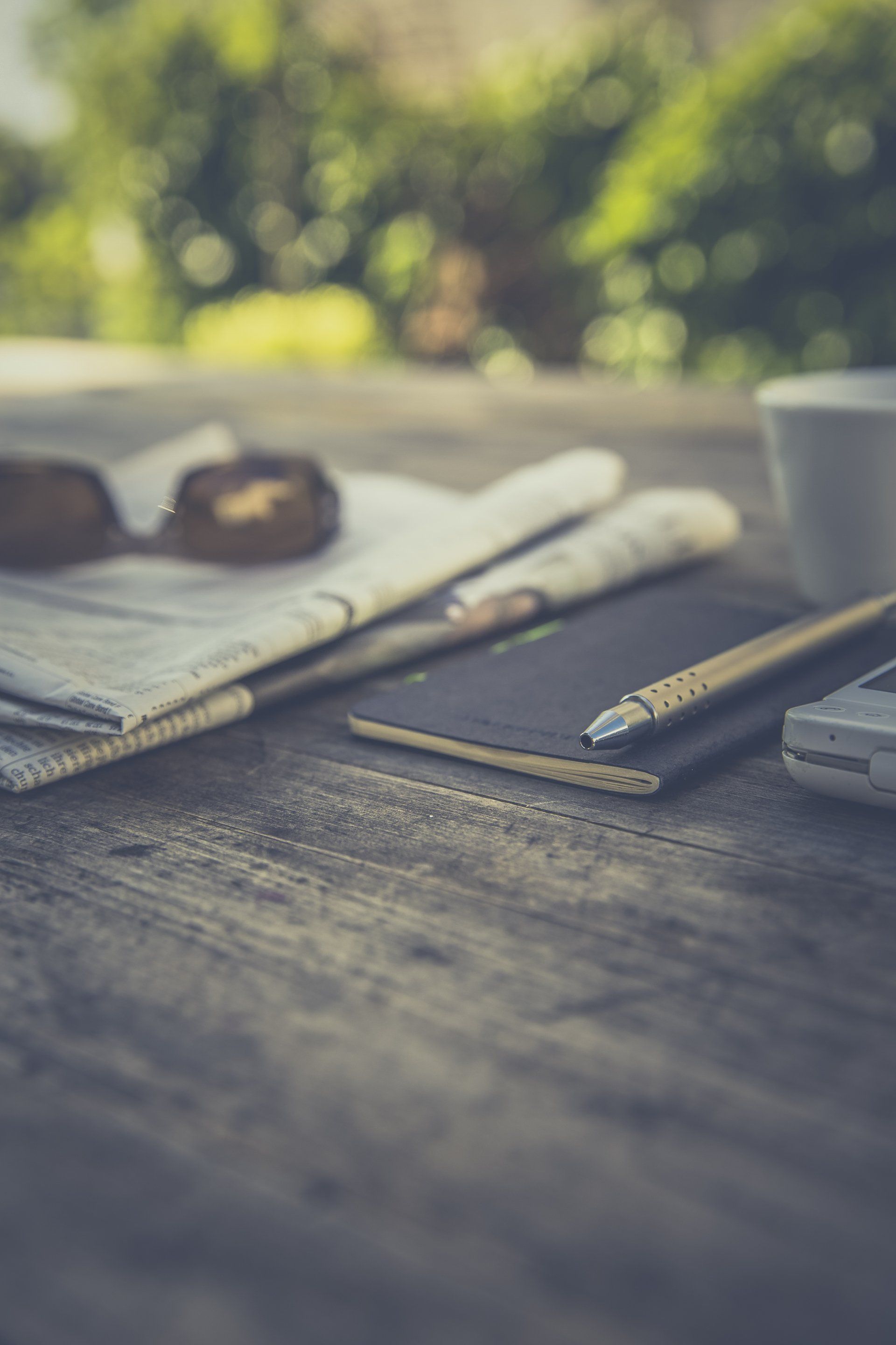 journal and newspaper on a table outside