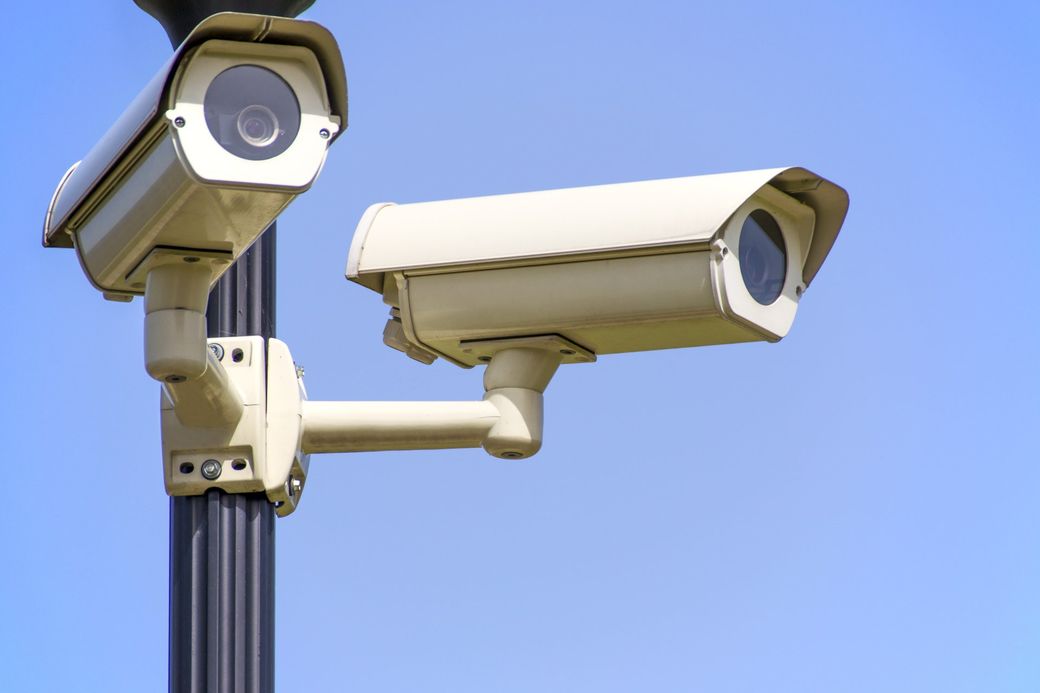 a security camera is mounted to a wooden post
