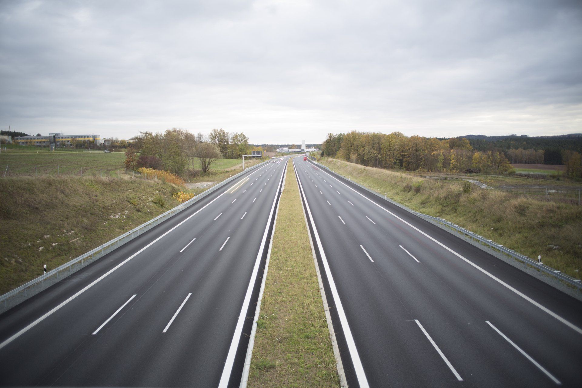 an empty highway with trees on the side of it