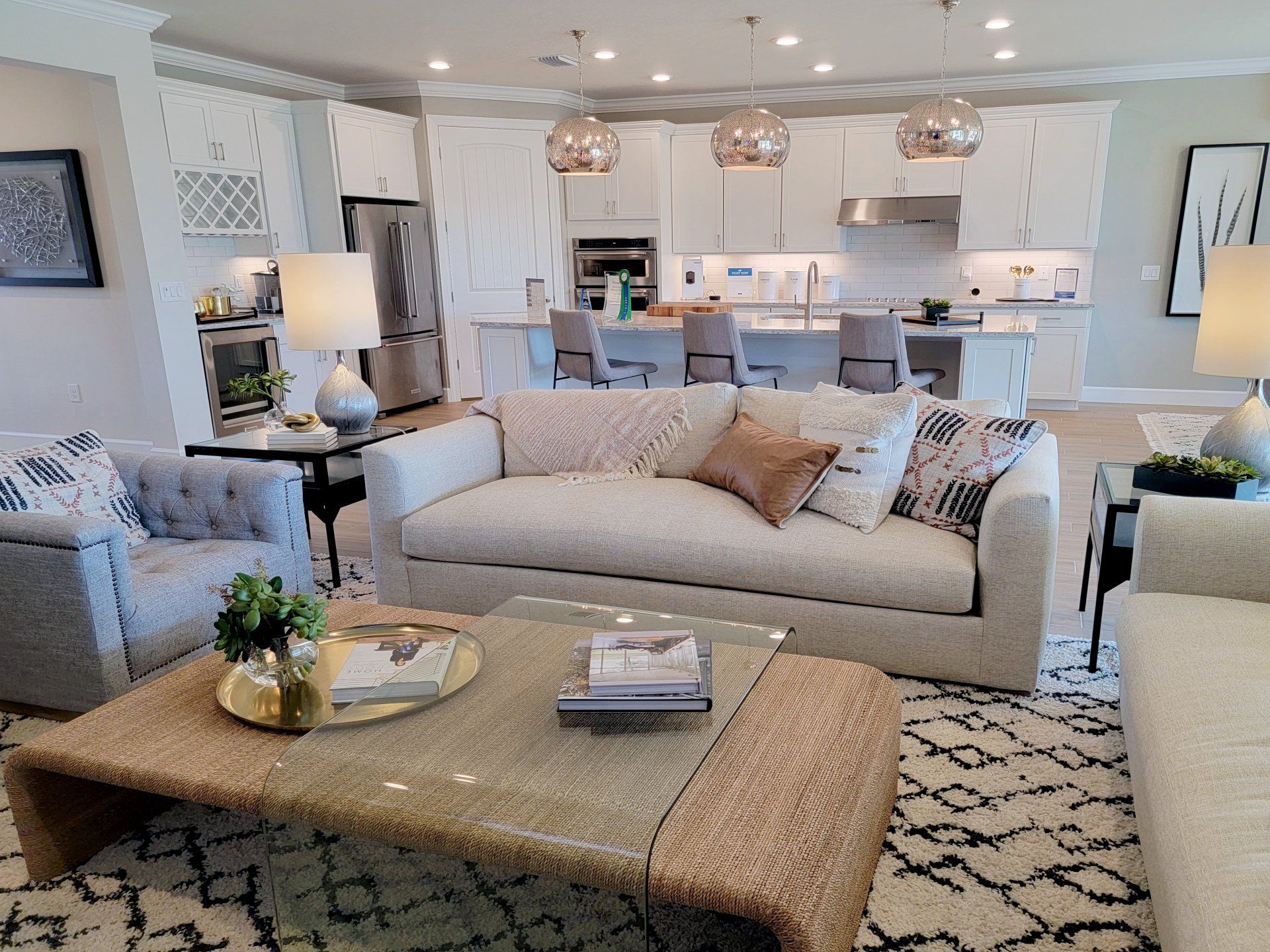 a kitchen with white cabinets and black counter tops
