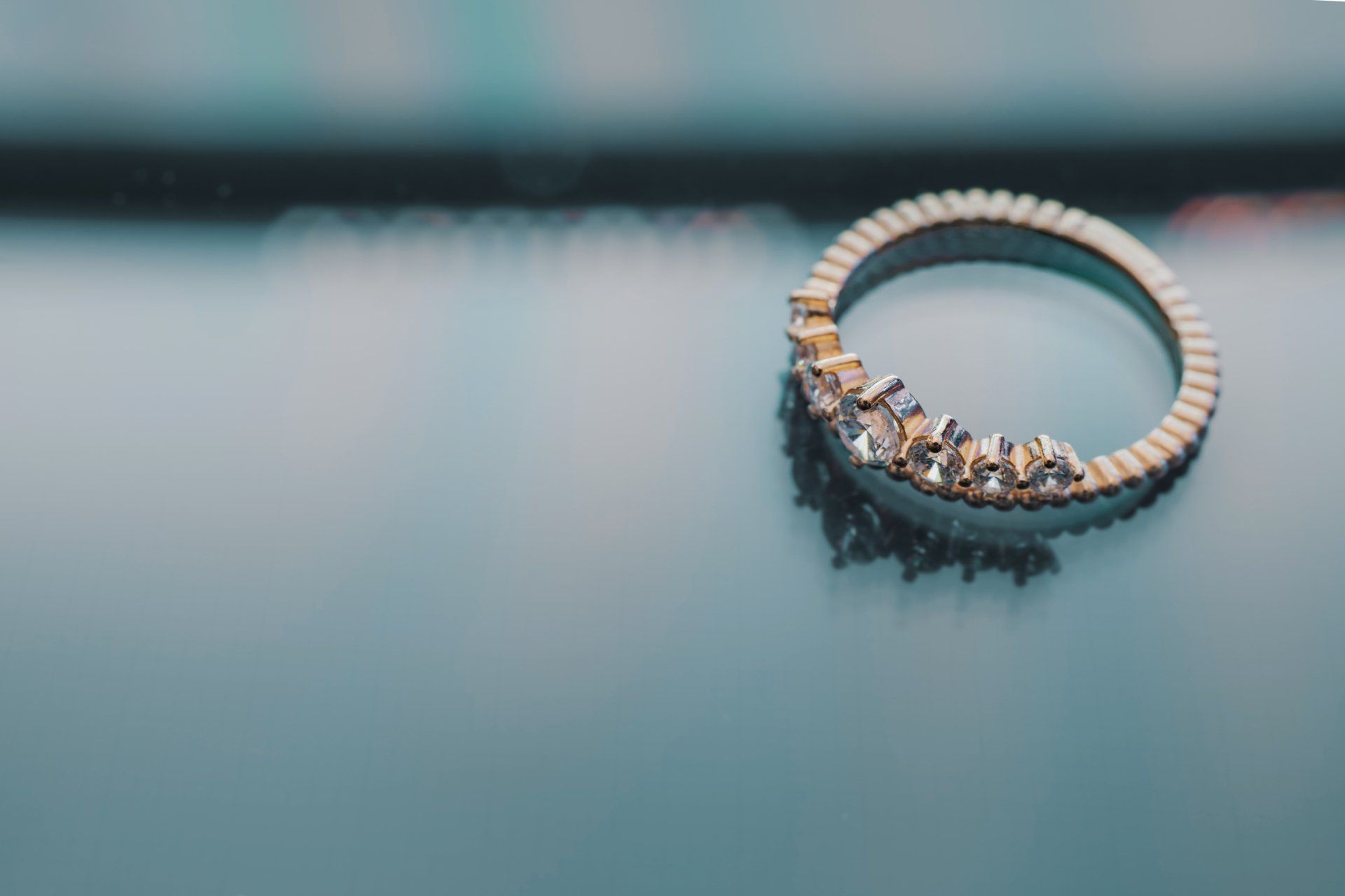 A close up of a diamond ring on a table.