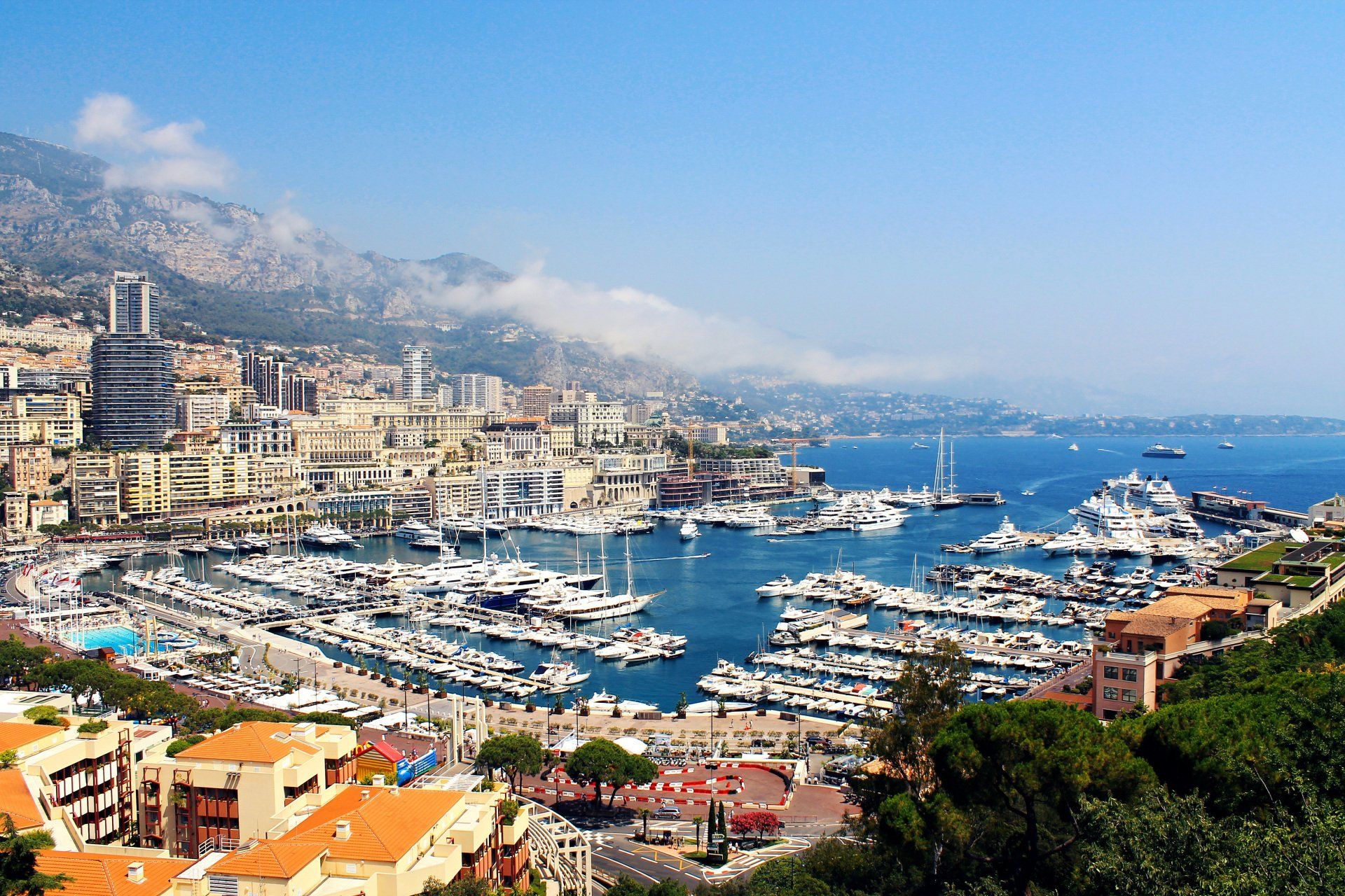 An aerial view of a city with boats docked in the water