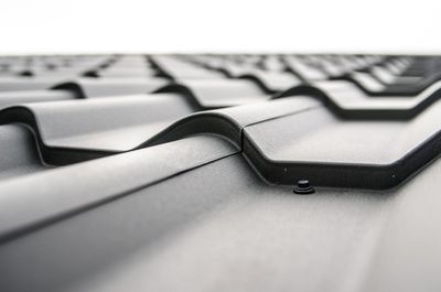 A close up of a roof with a screw in it.
