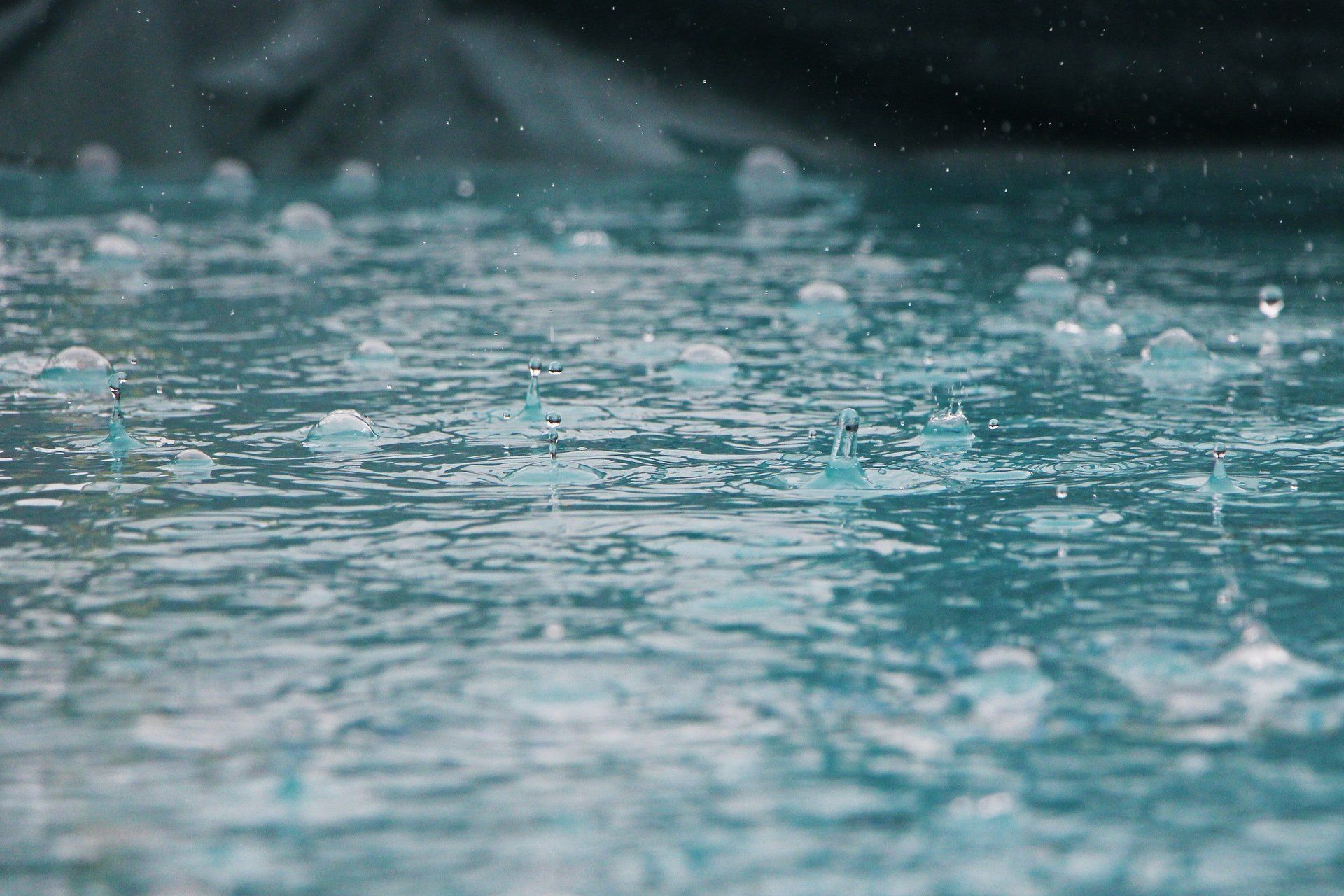 close up of rain falling on water