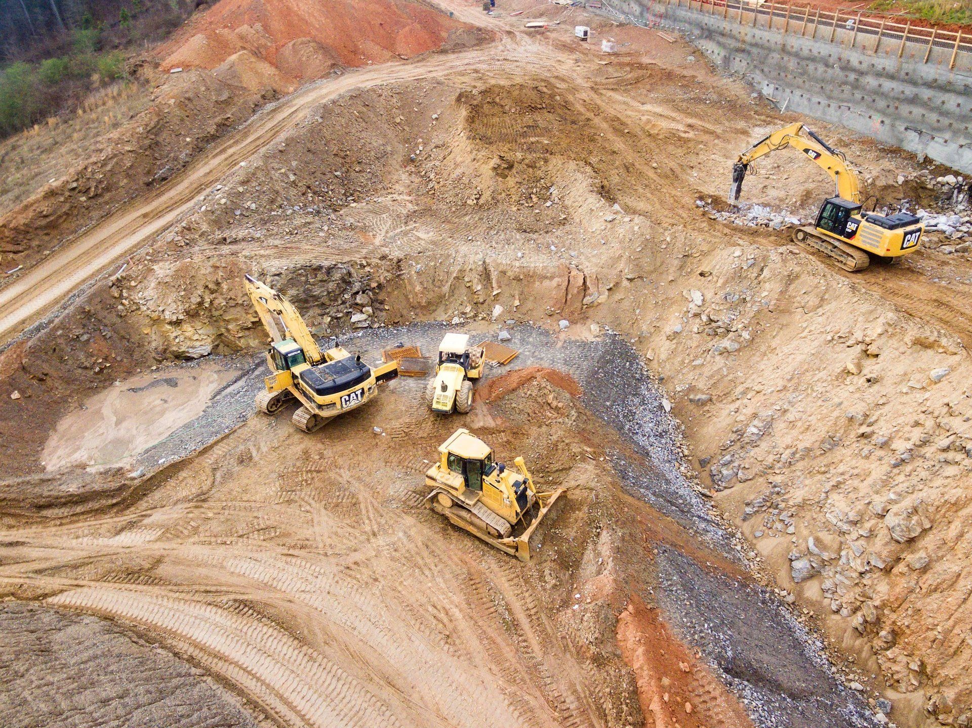 An aerial view of a construction site with bulldozers and excavators.