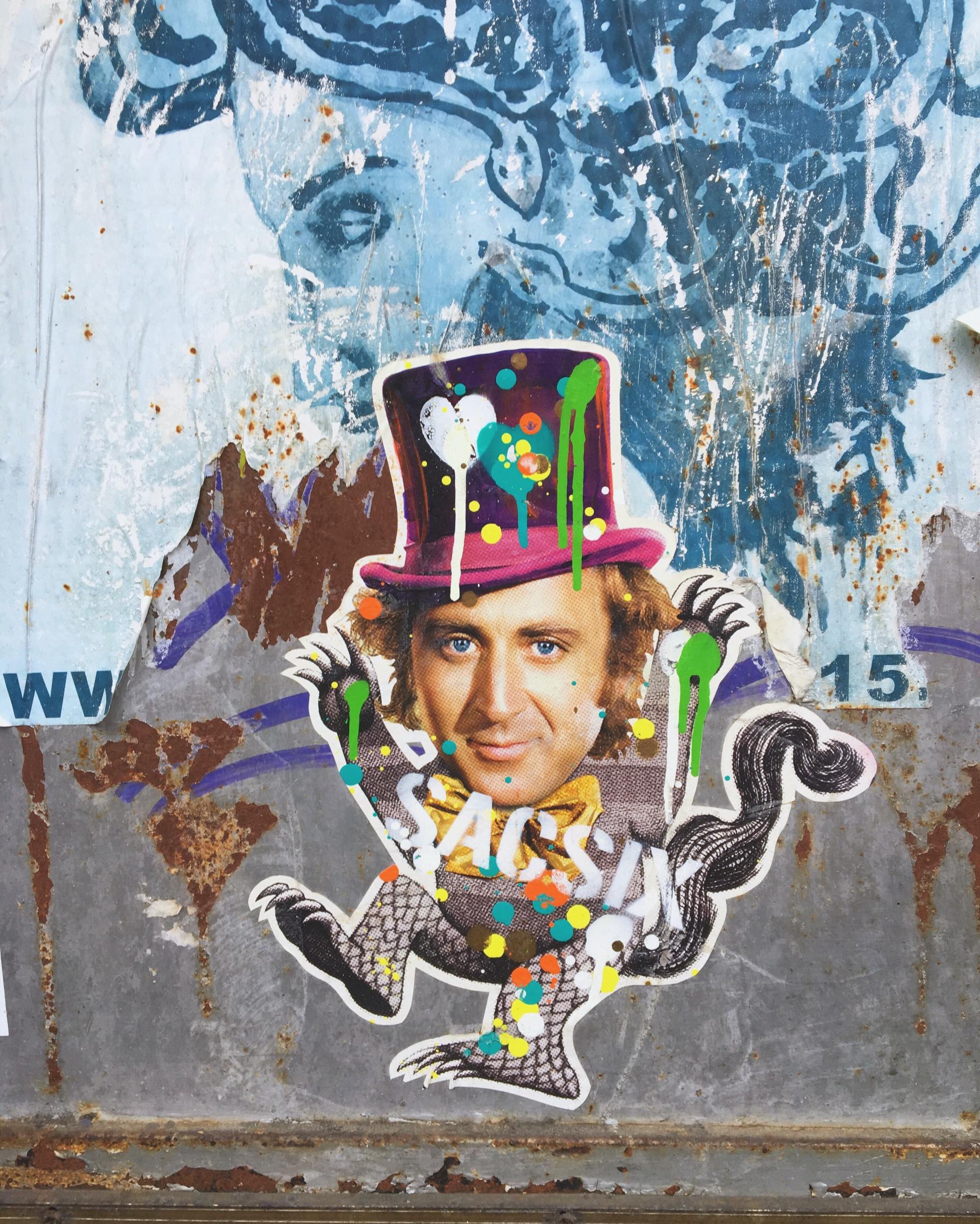 A sticker of a man wearing a top hat with a heart on it