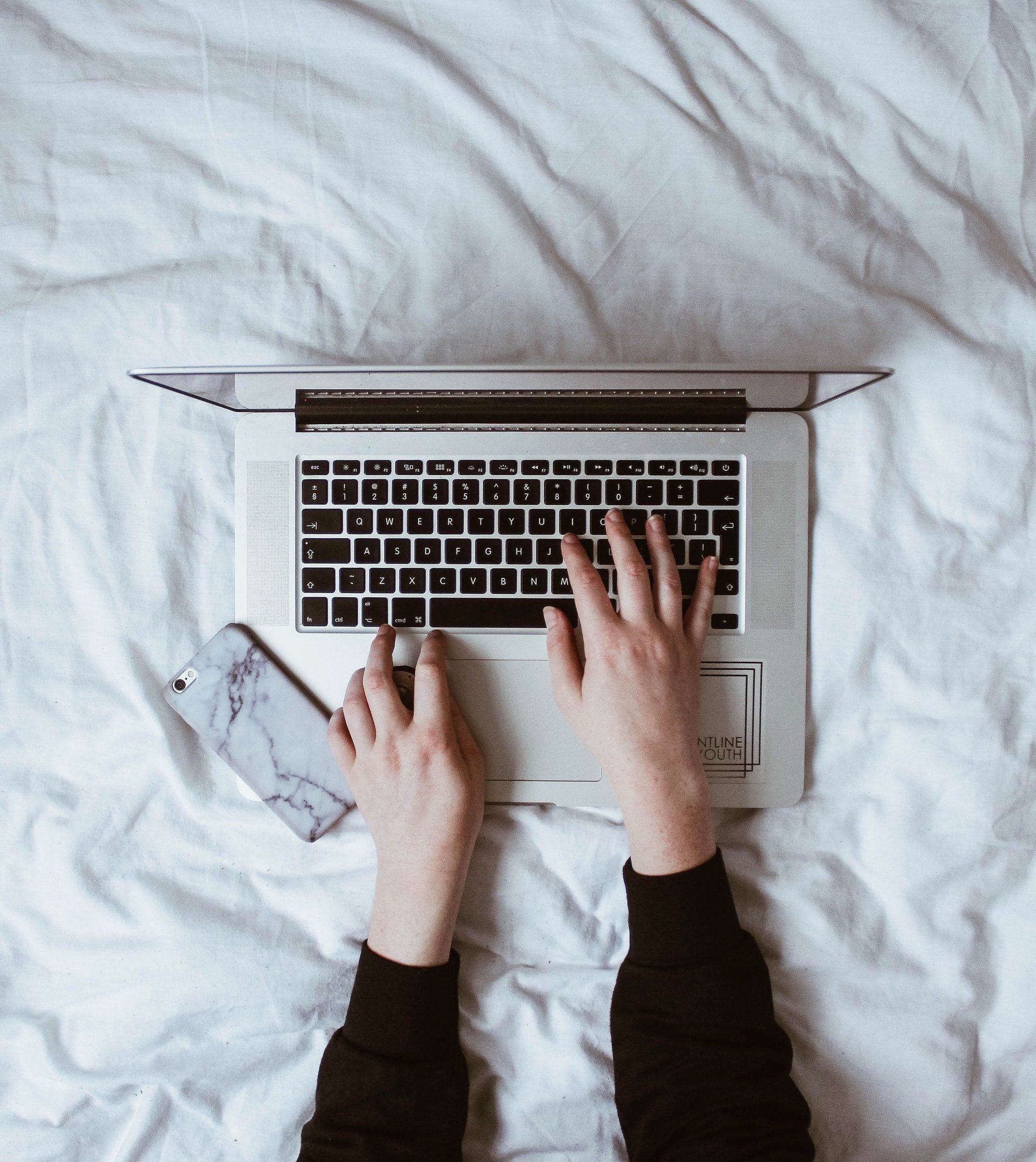 person typing on laptop