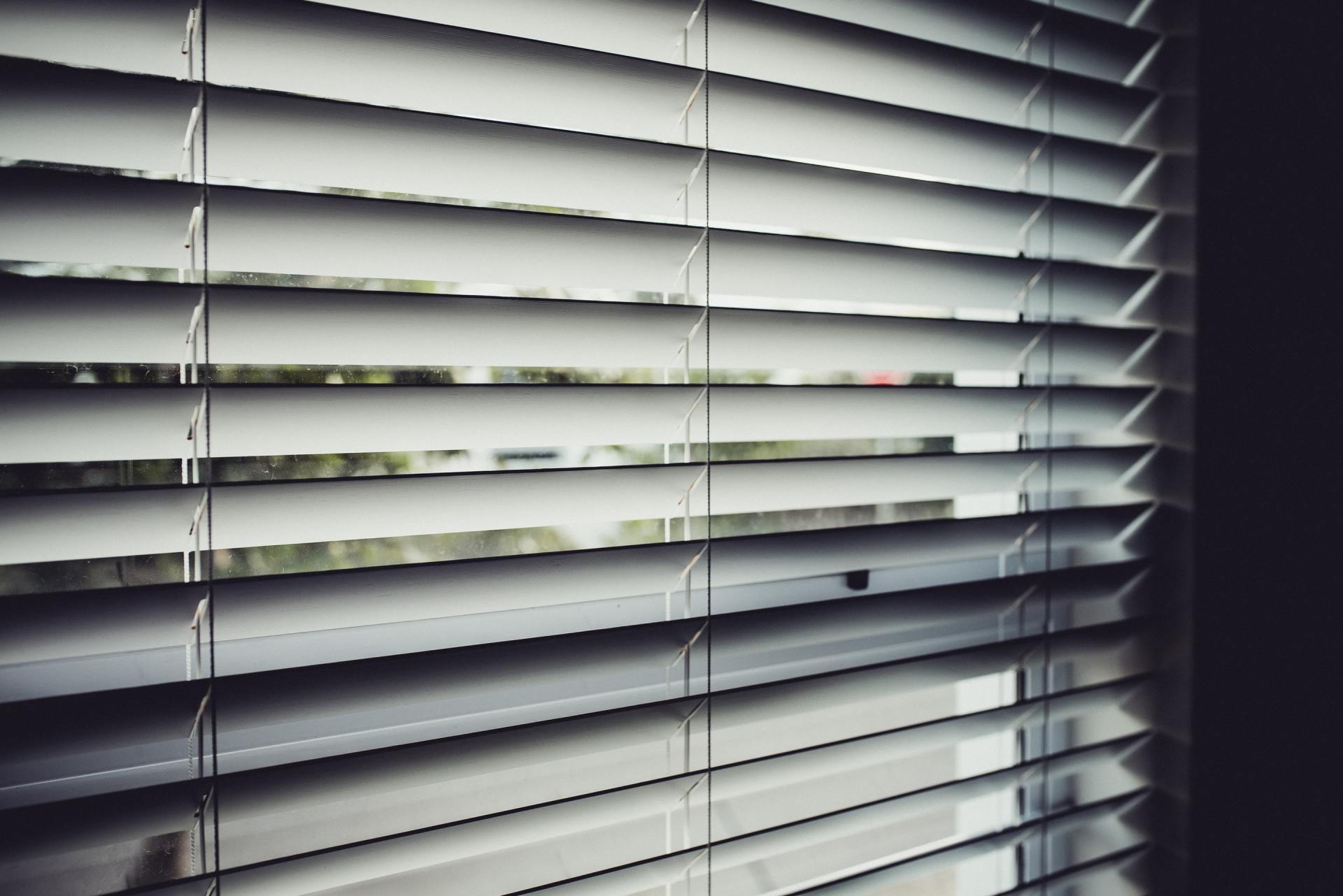 A close up of a window with blinds on it