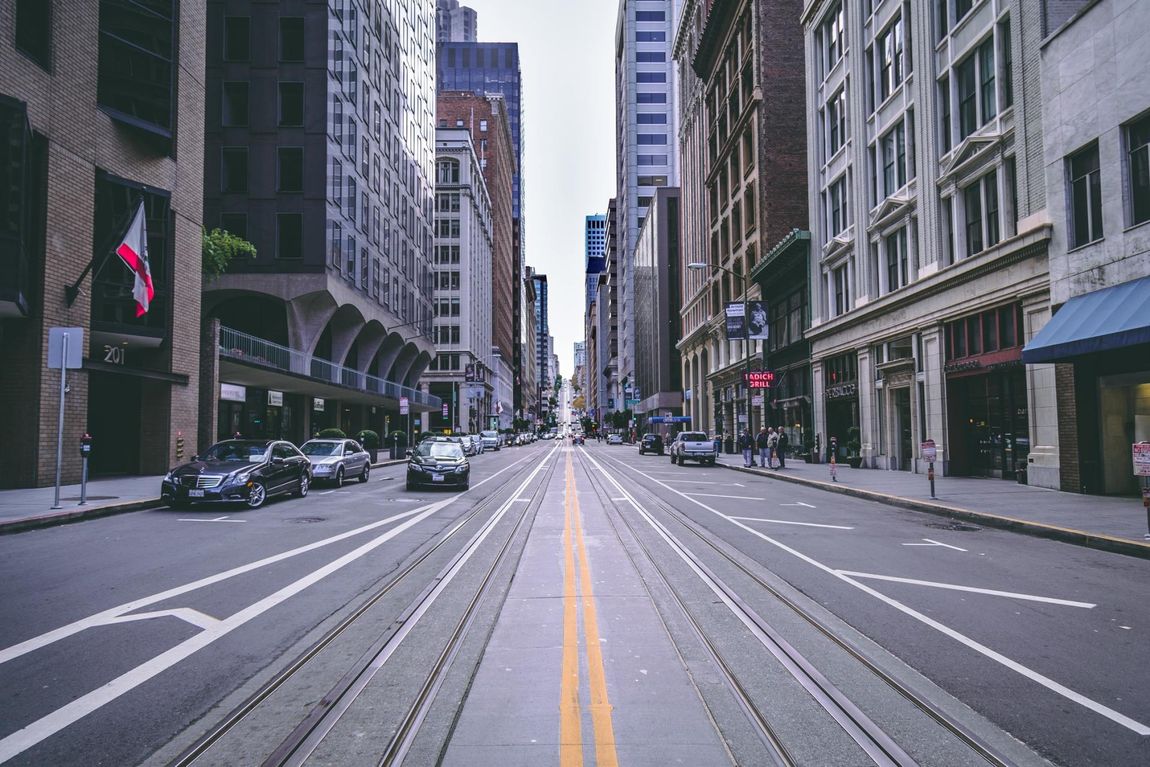 a busy city street with a sign that says no parking