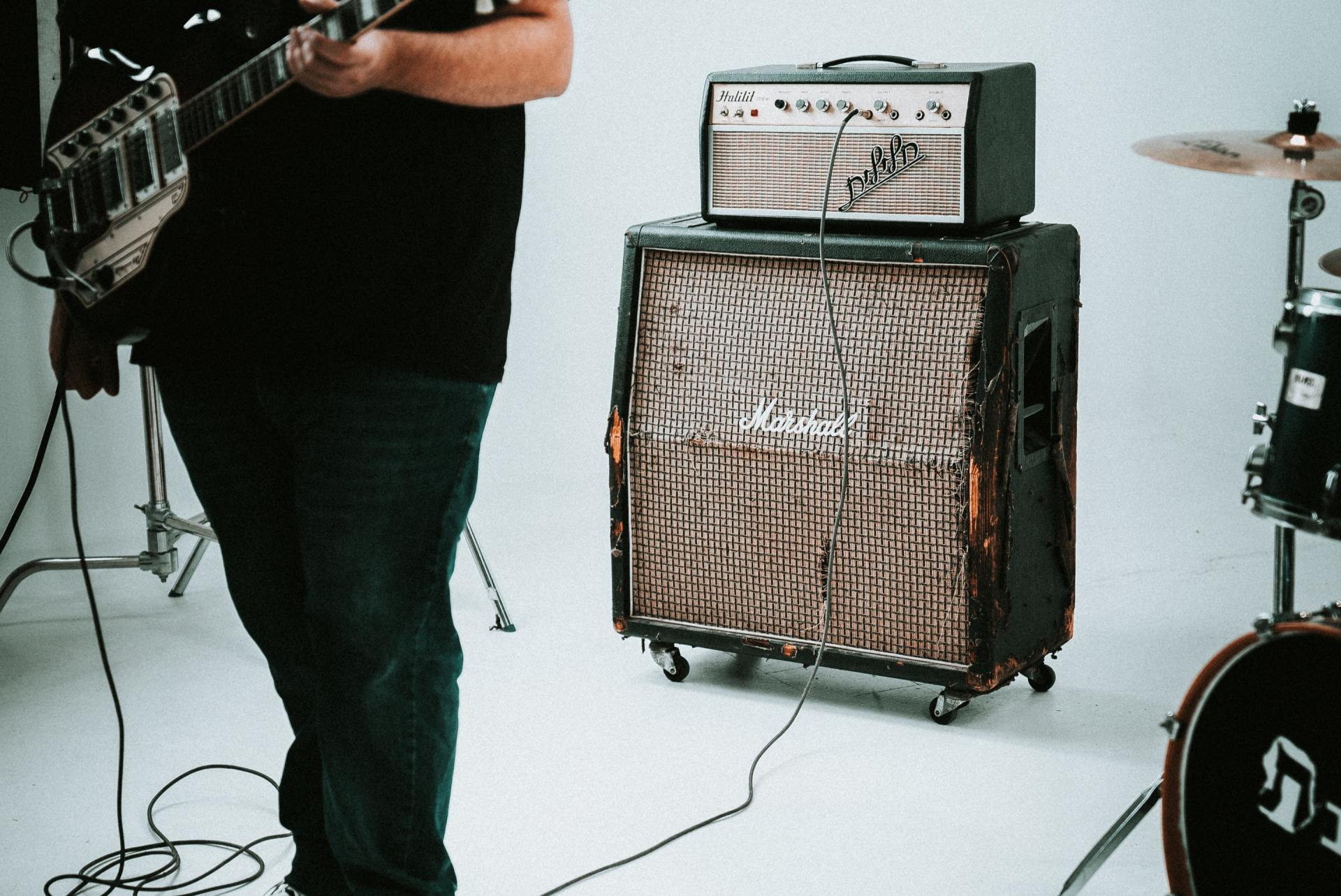 Musician in front of a guitar amplifier