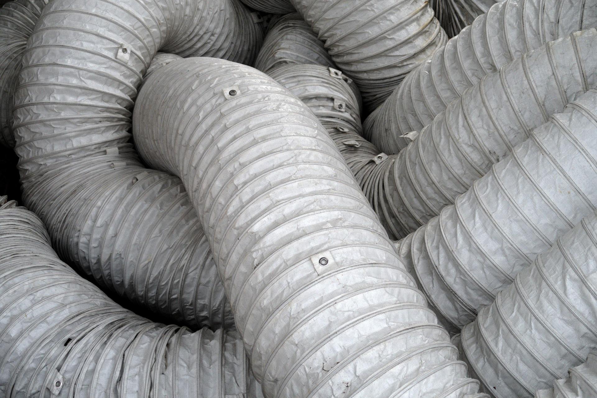 Coiled, gray flexible ventilation ductwork.