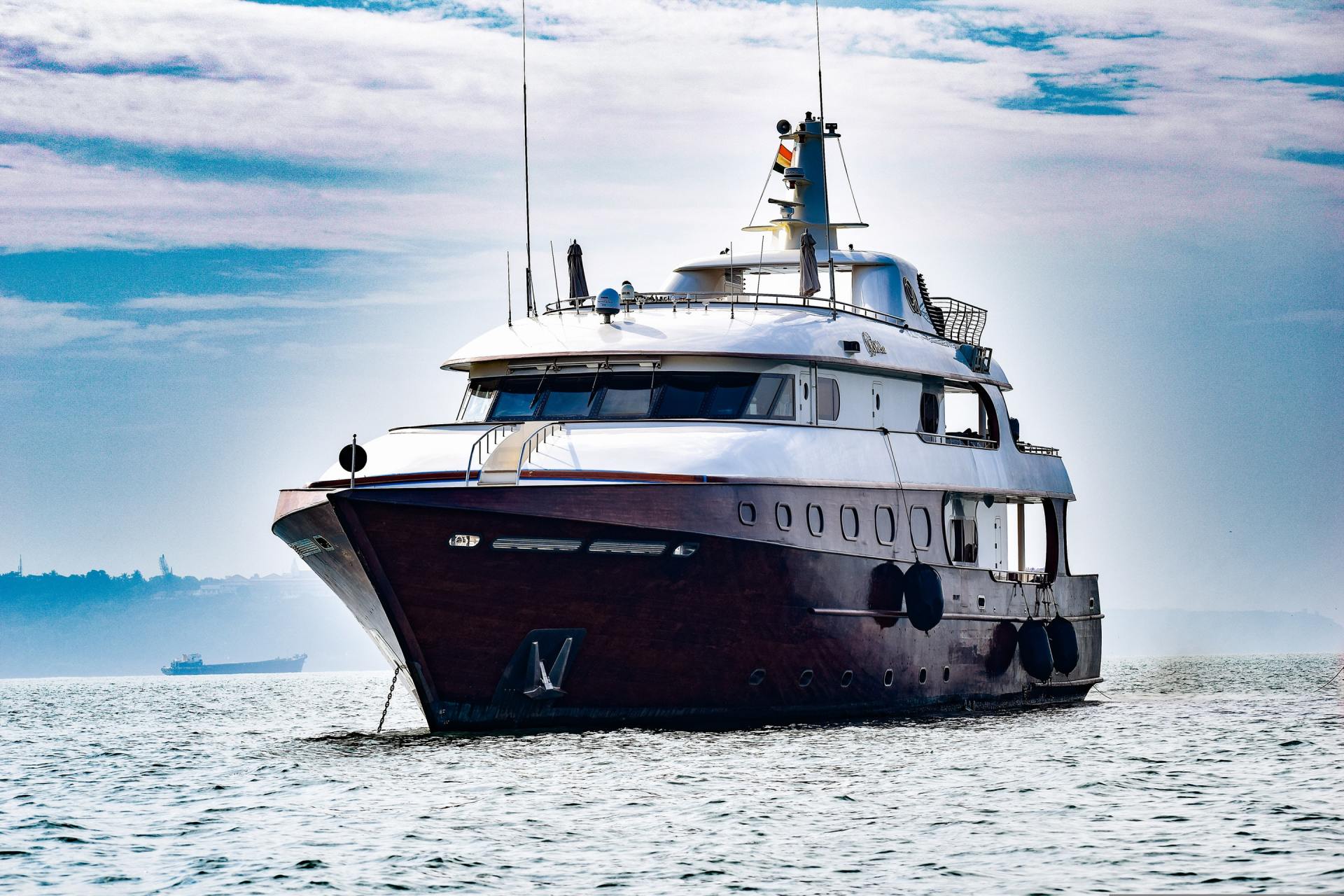 A large boat is floating on top of a body of water