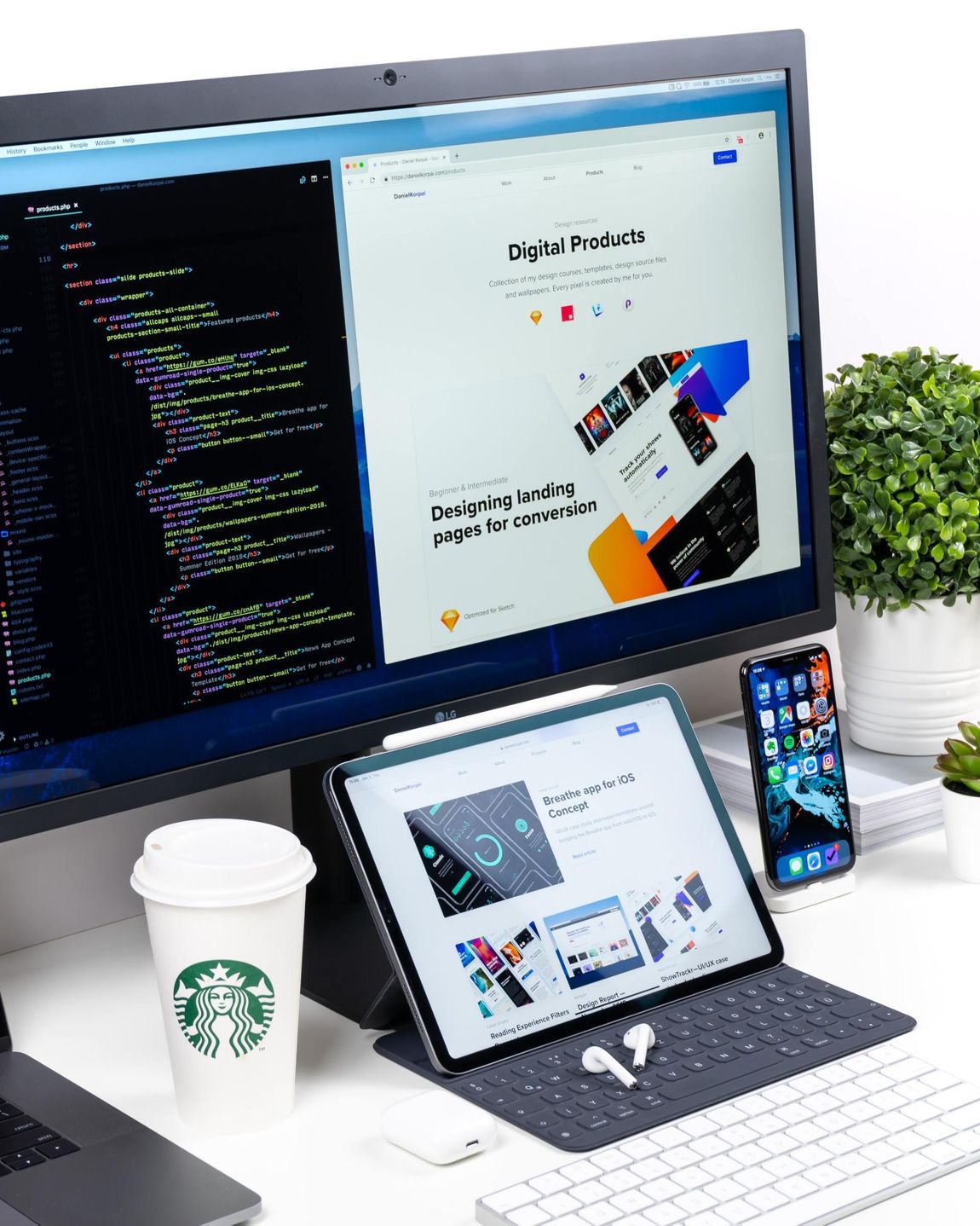 a starbucks cup sits on a desk next to a computer monitor