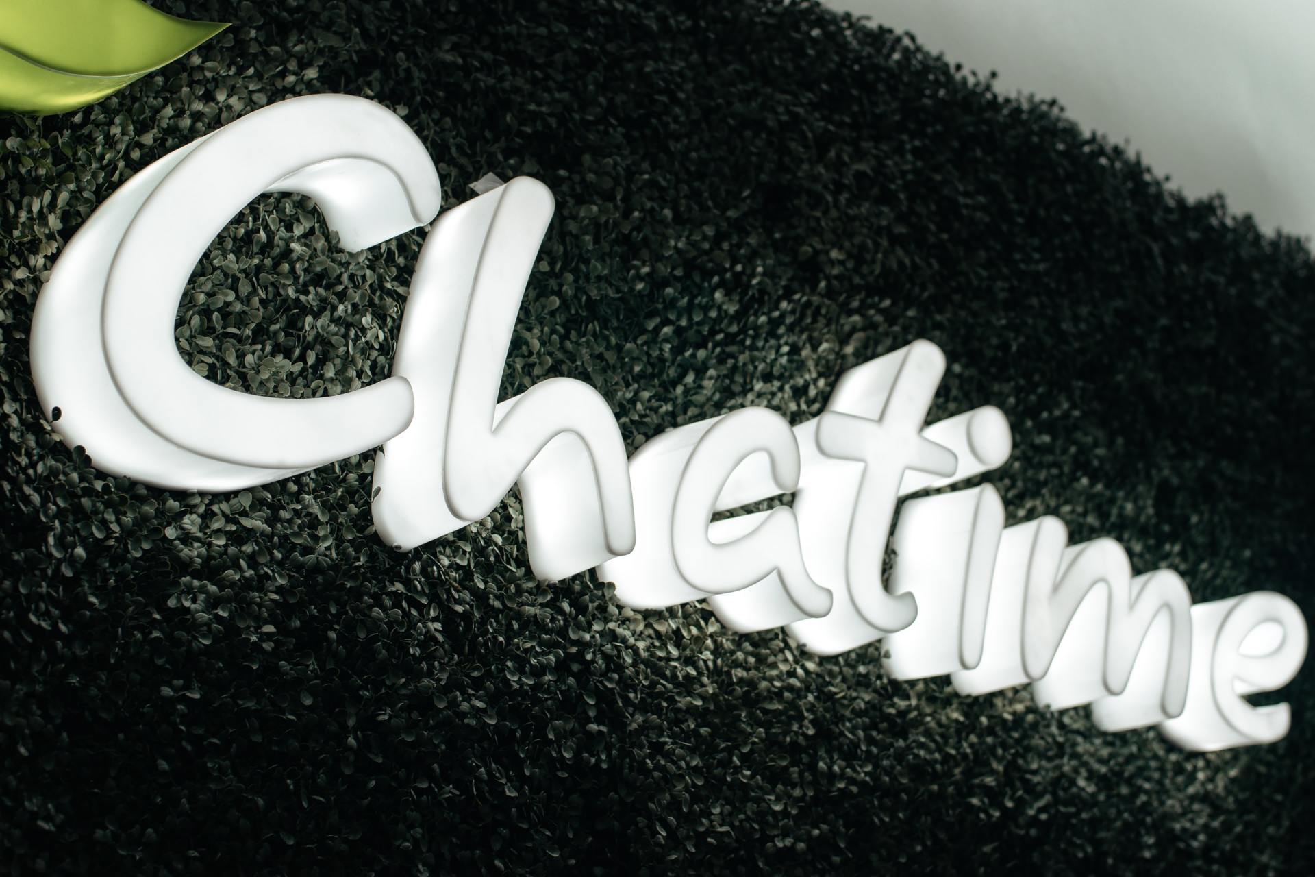 White Chatime logo on a dark, textured background.