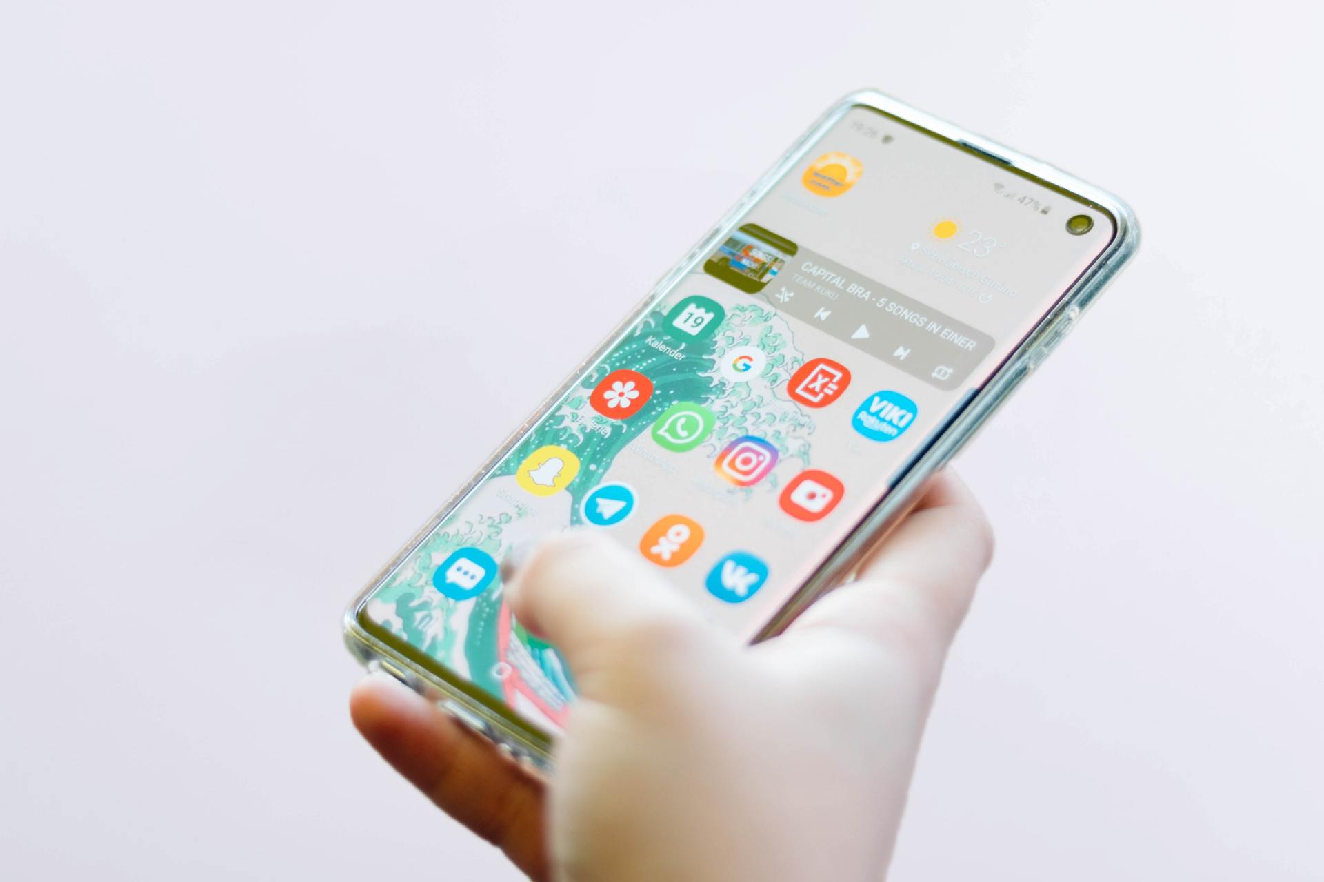 A person is holding a cell phone in their hand.