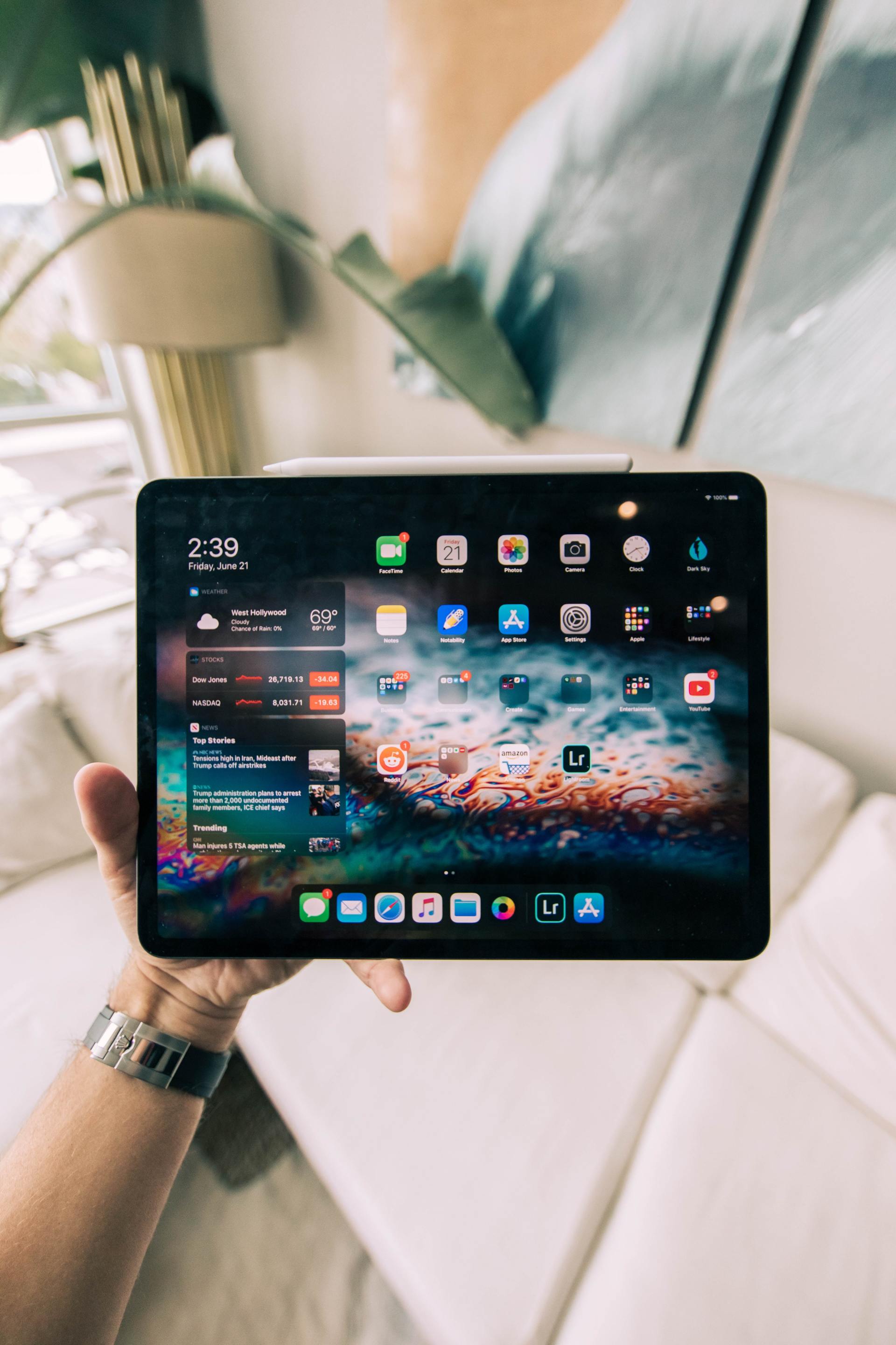 A person is holding a tablet in their hand.