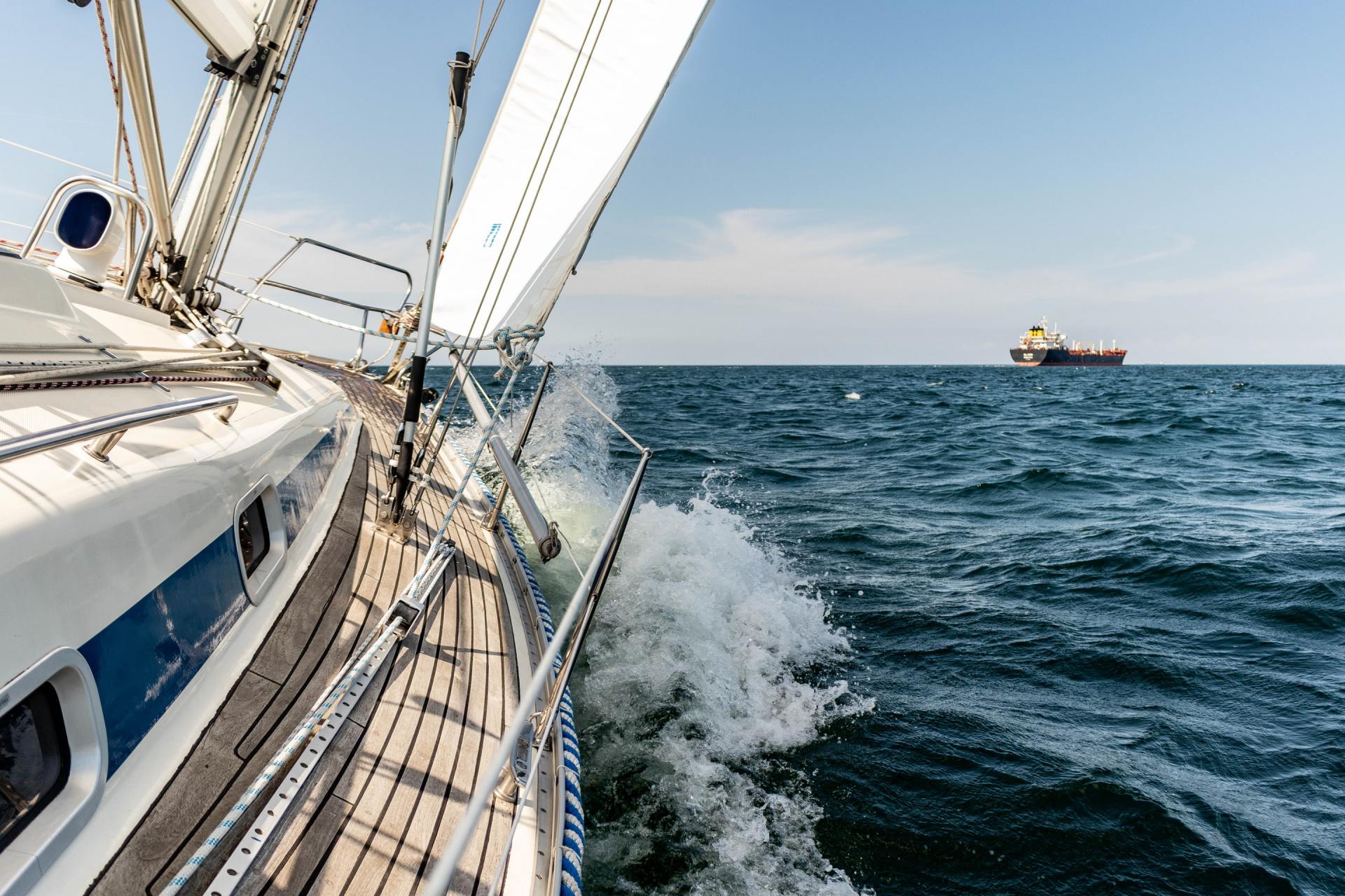 A sailboat is floating on top of a large body of water.