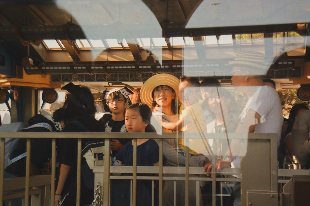 A group of people are sitting on a train looking out the window.