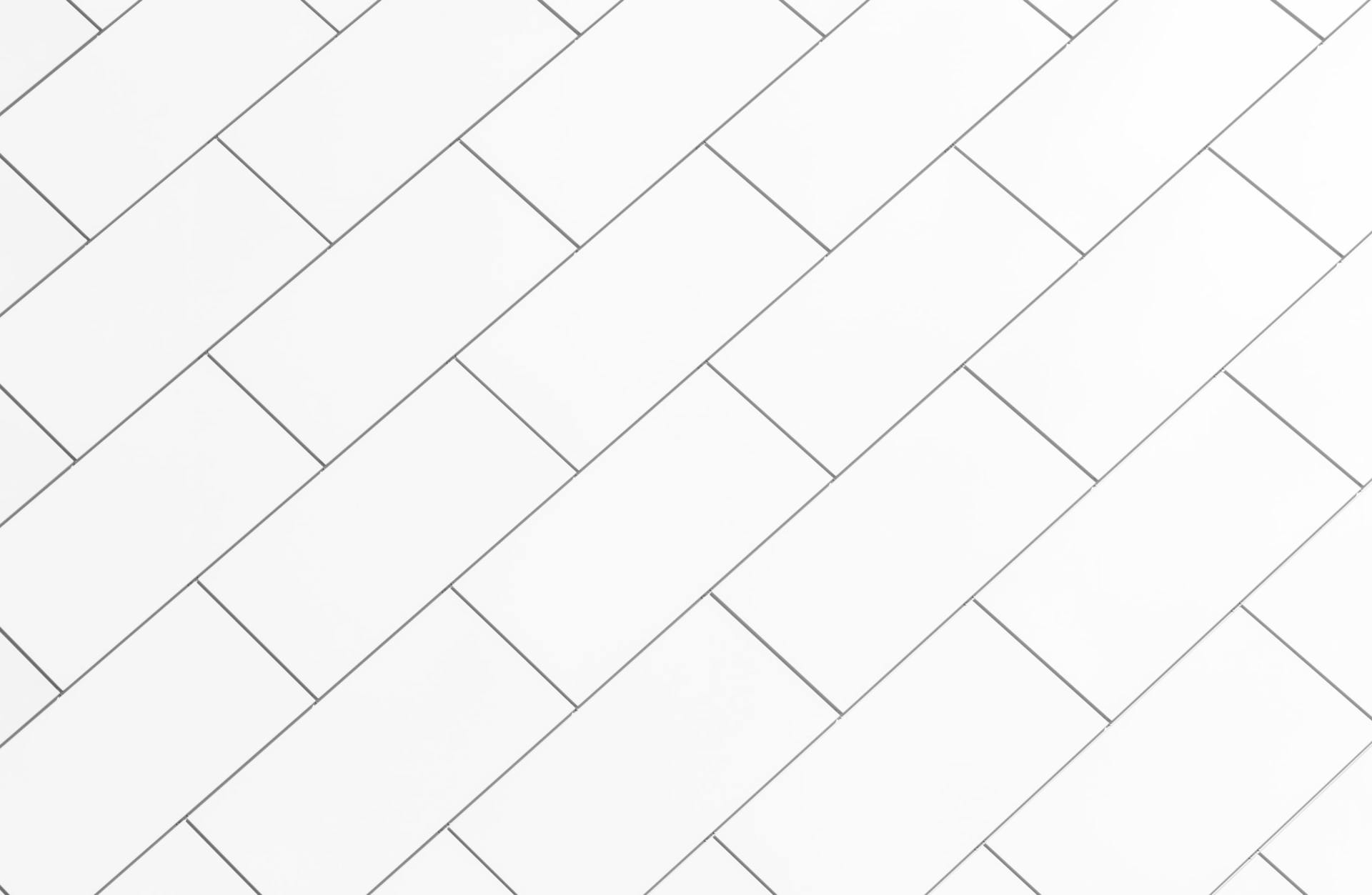 white staggered tiles with dark grey grout