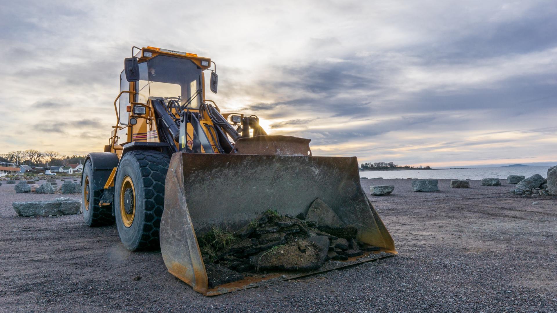 A bulldozer is sitting on top of a dirt field.