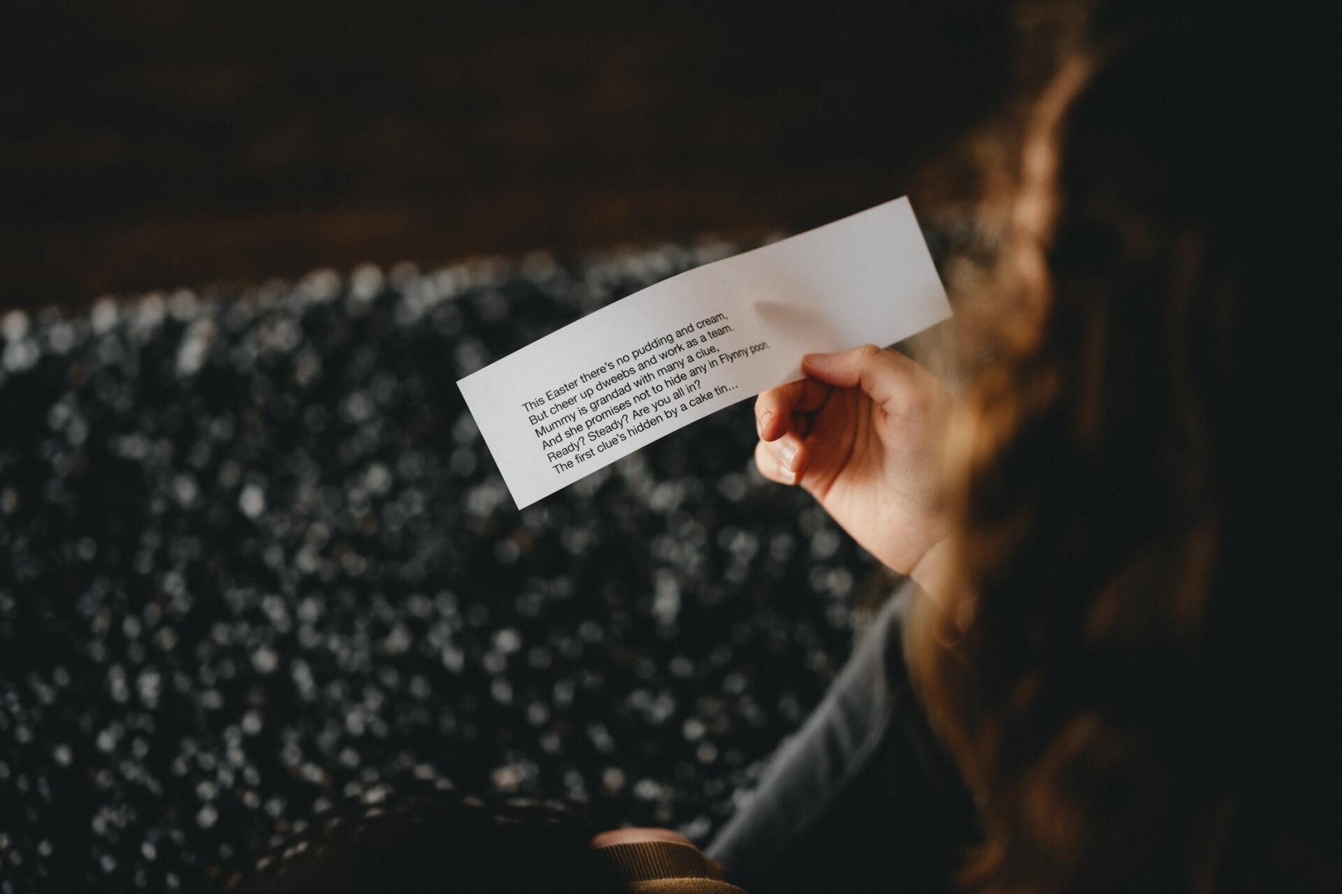 A woman holding an escape room clue