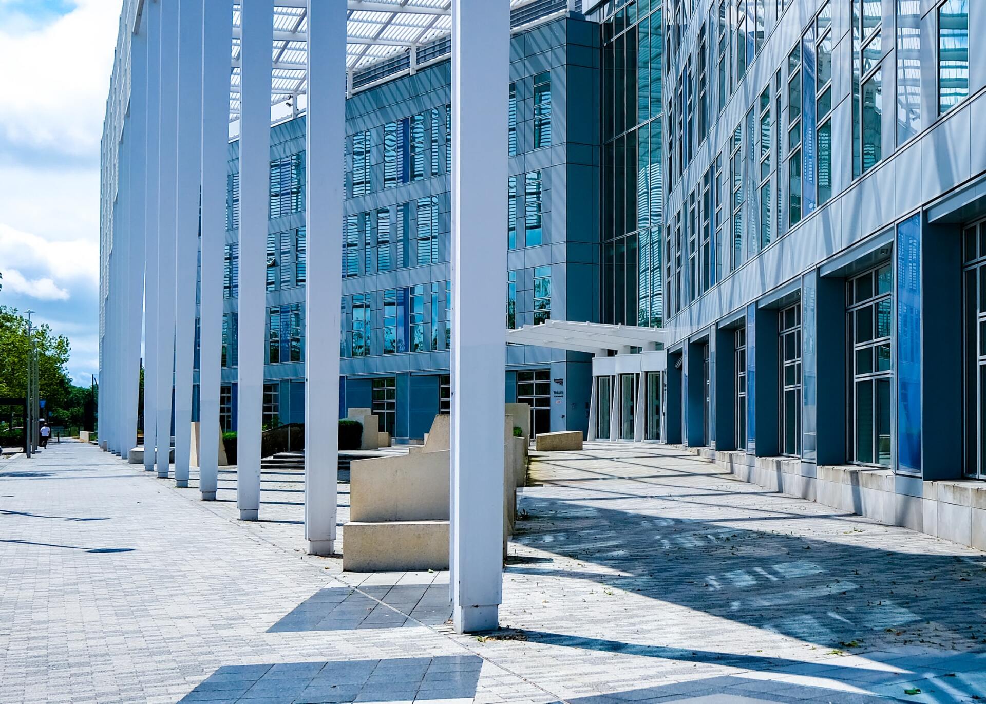 A large building with a lot of windows and columns in front of it