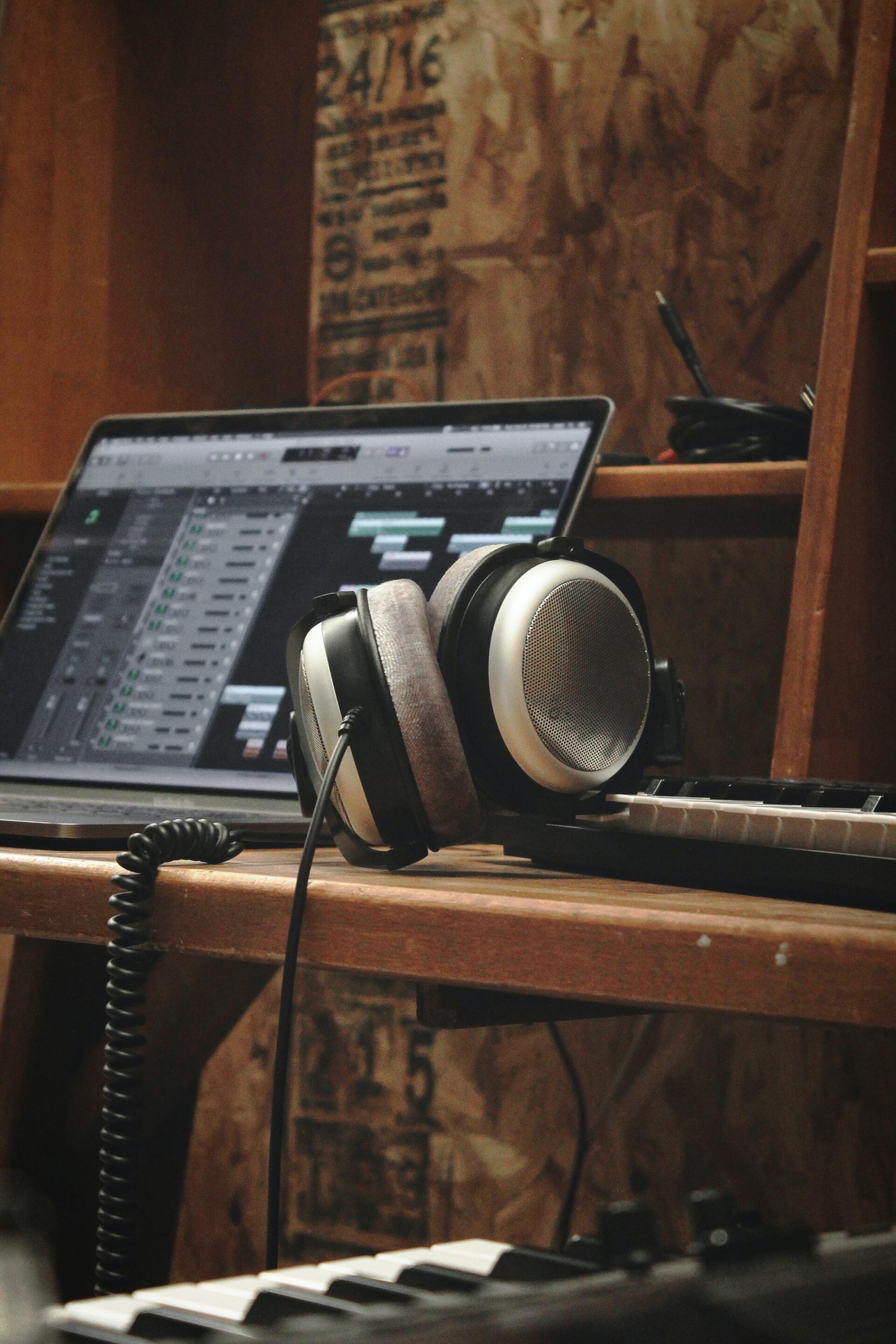 Headpohnes on desk beside a computer
