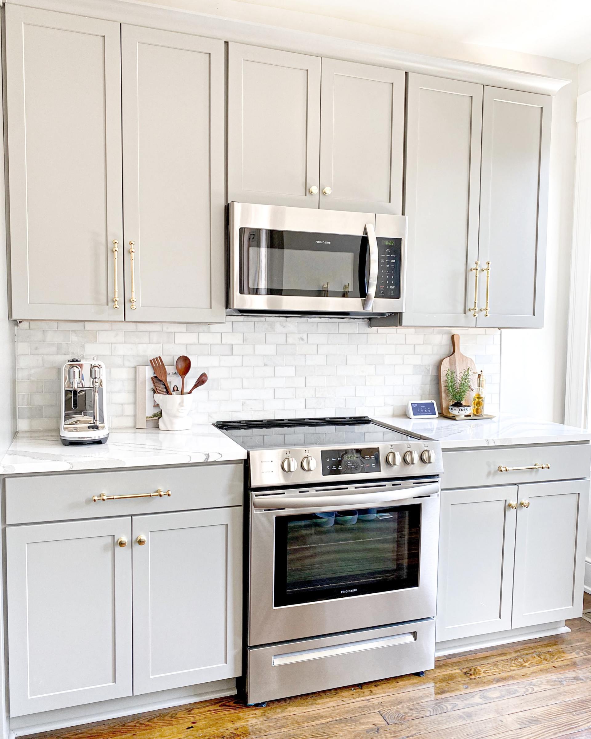A kitchen with stainless steel appliances and white cabinets.