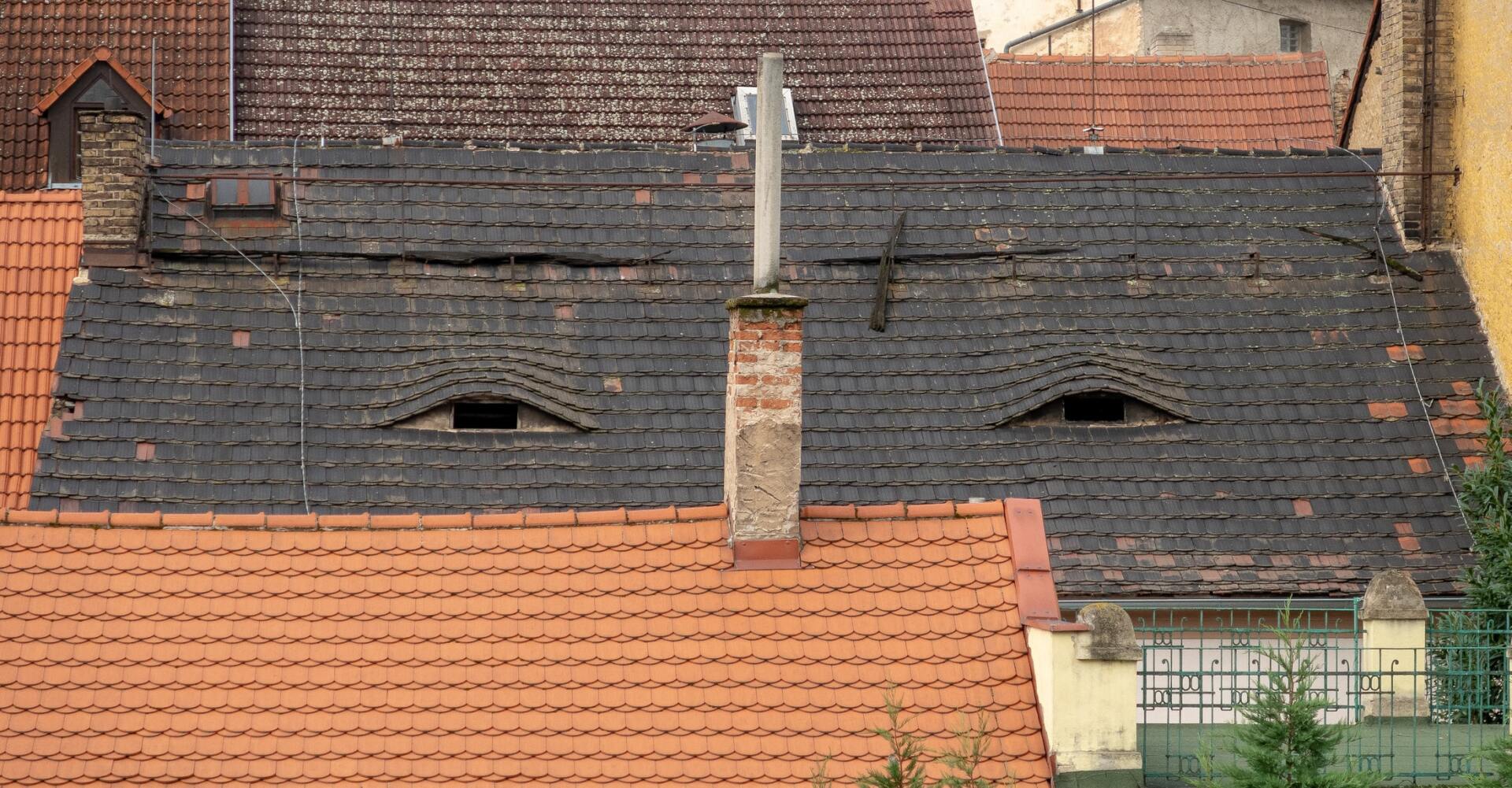 A roof with a chimney that looks like a face