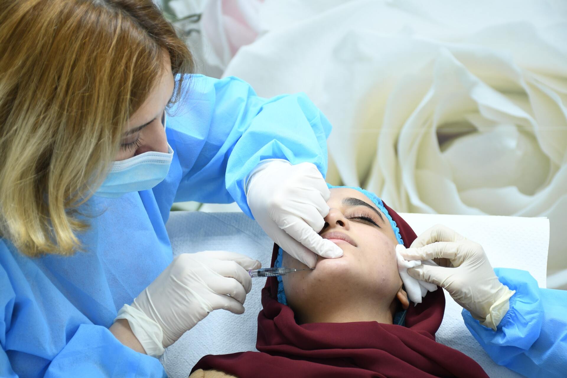 A woman is getting a botox injection in her face.
