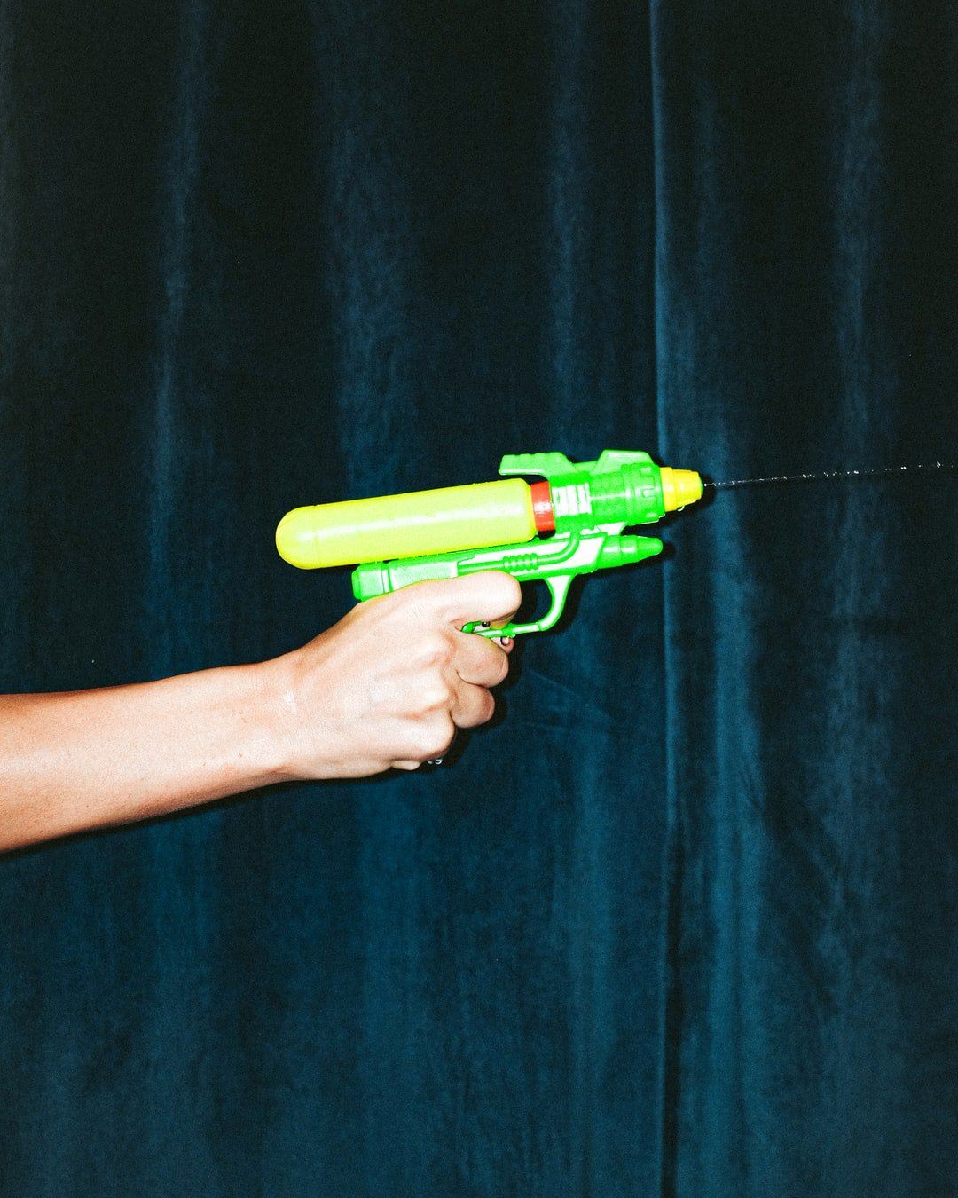 Guy diving and shooting two water pistols