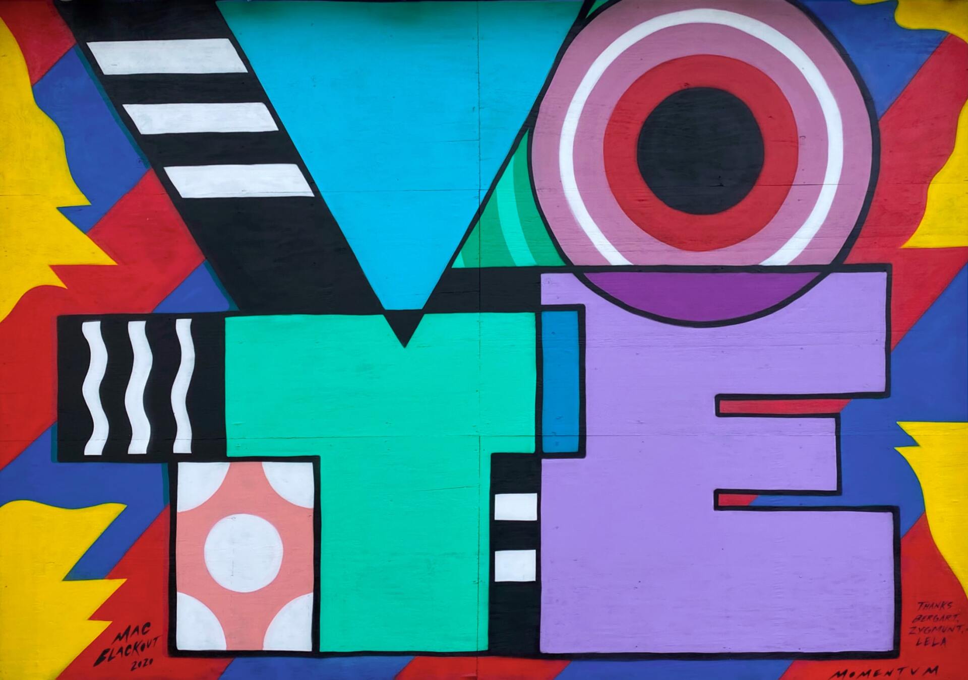 A colorful painting of the word vote on a wall