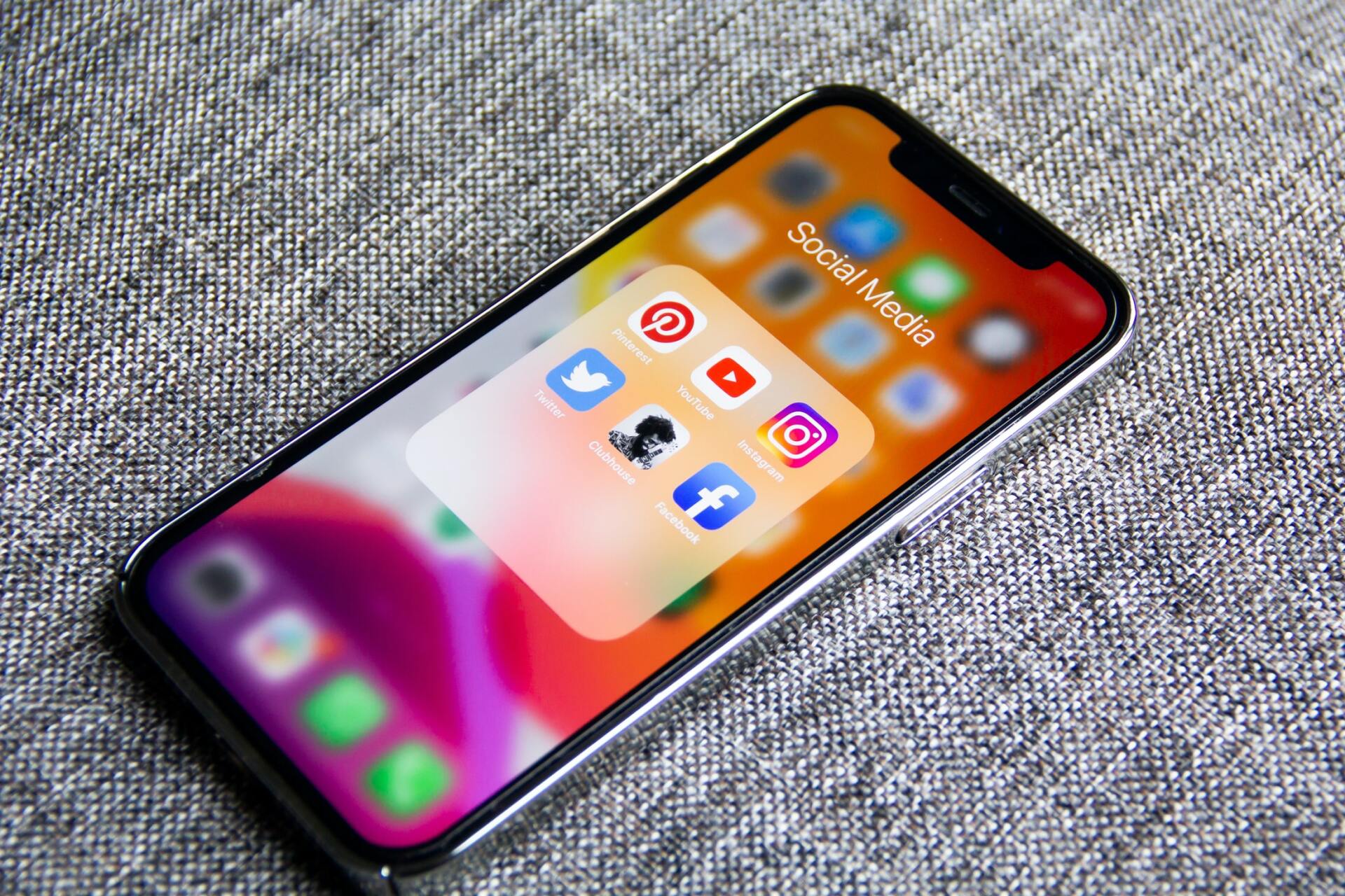 A cell phone with social media icons on the screen