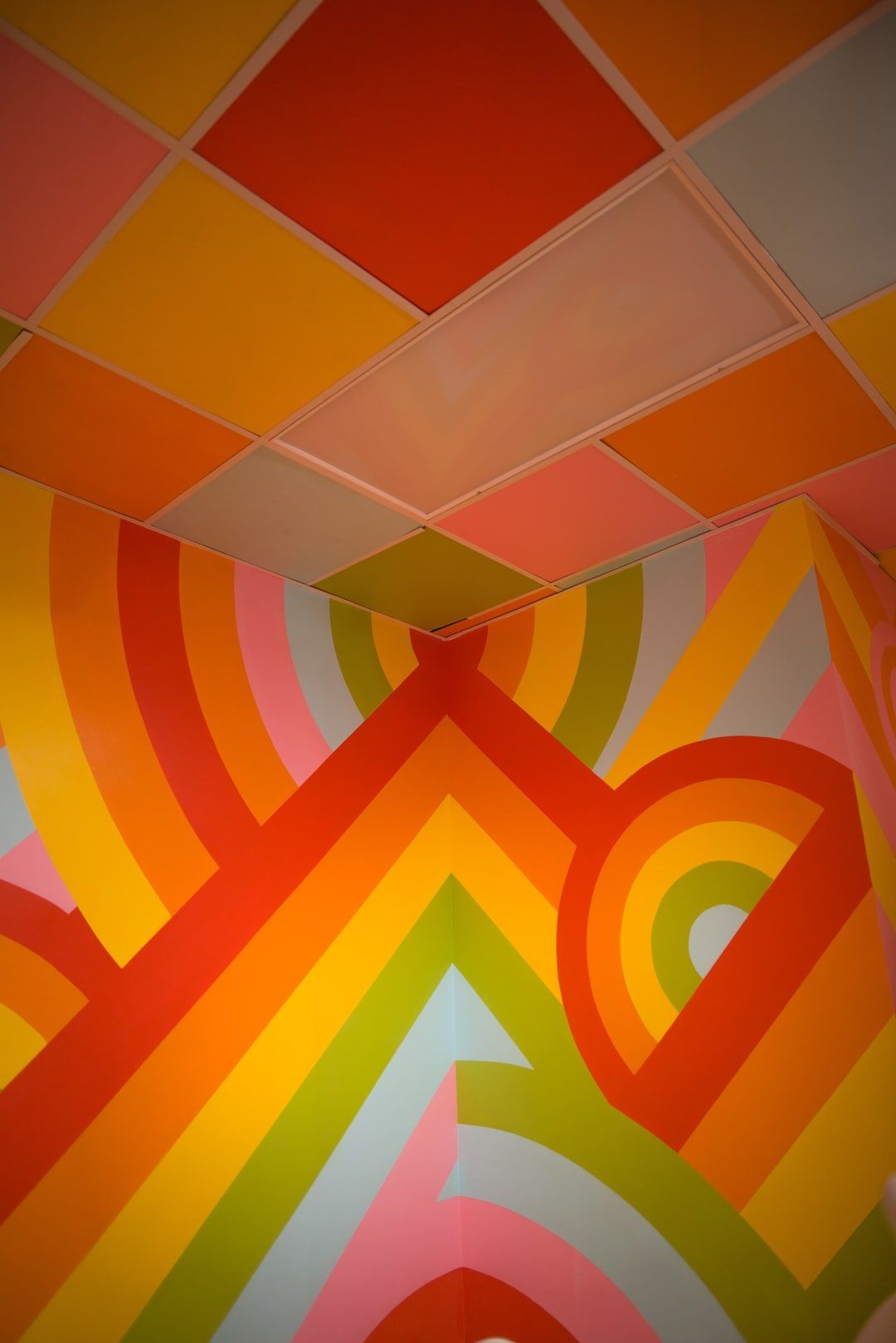 A room with a colorful painting on the wall and ceiling.