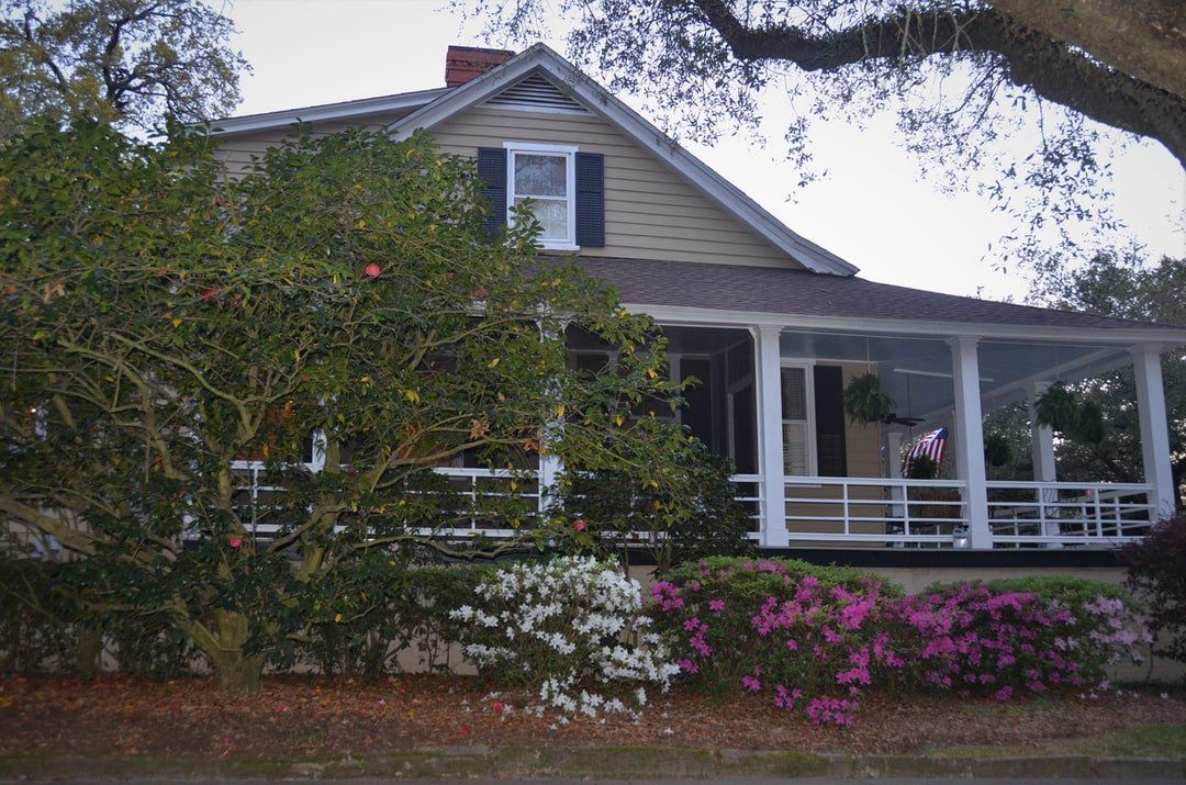house with purple and white flowers in front