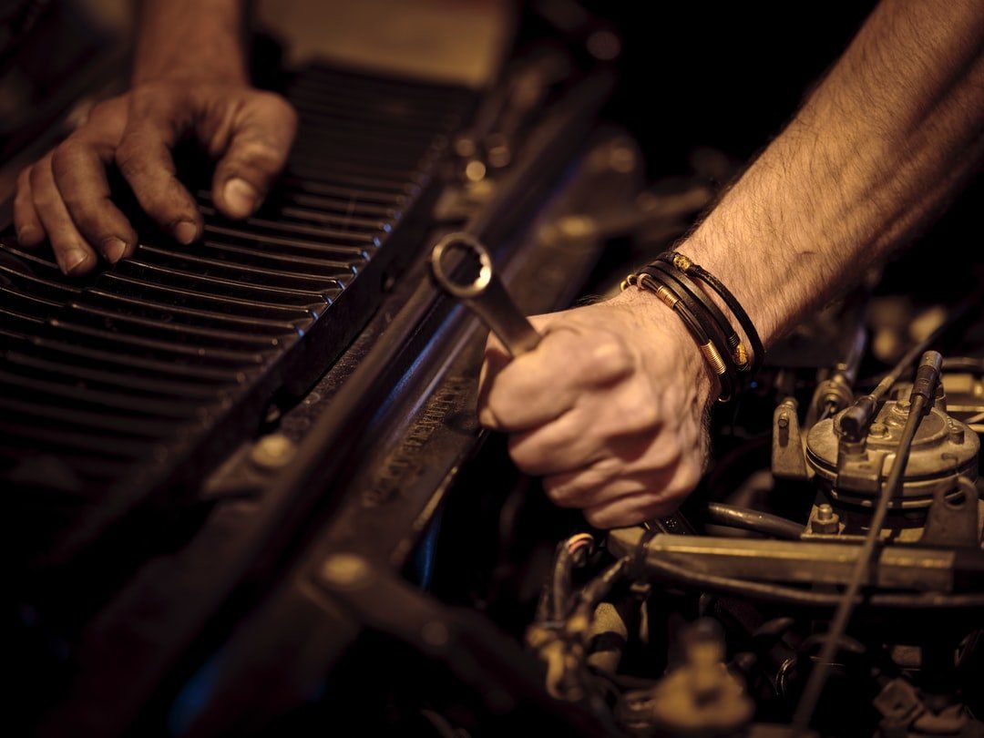Mechanic working on an auto engine at Bucholtz Transmission
