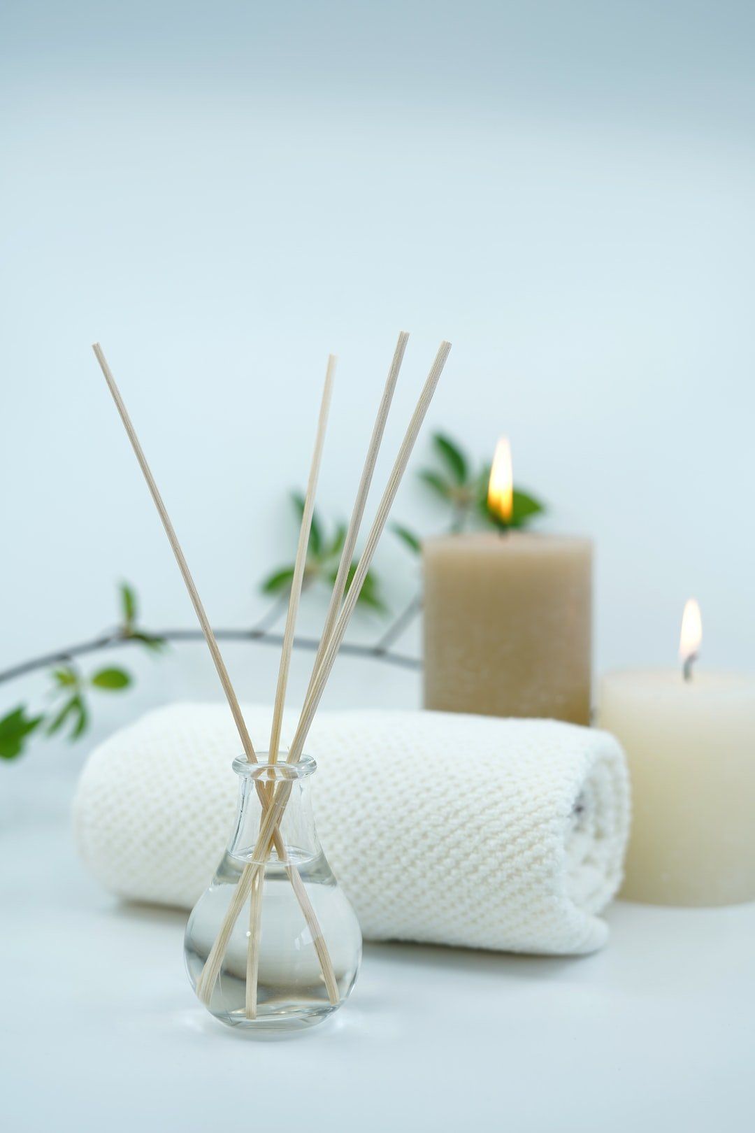 There are two candles and a towel on the table.