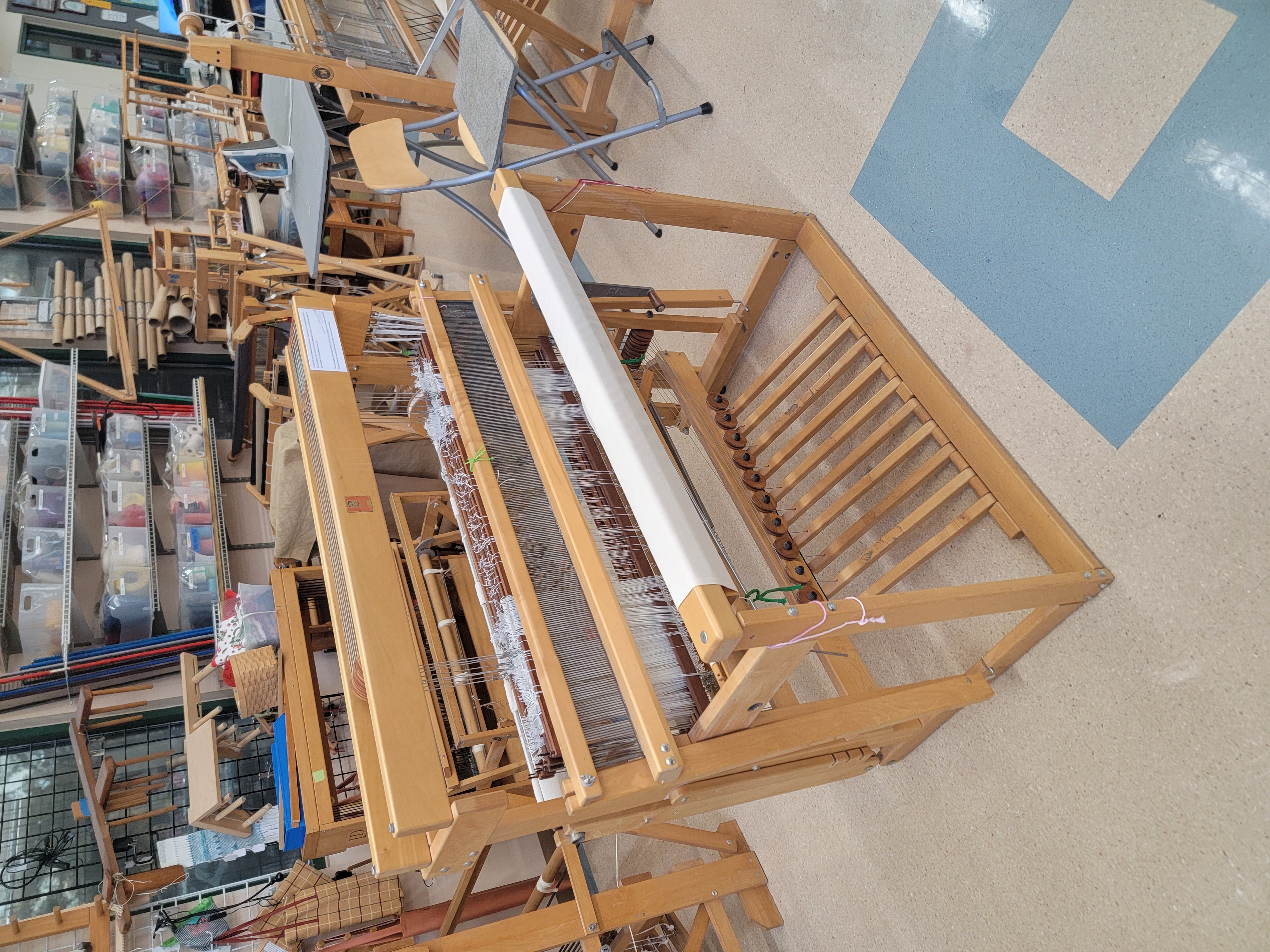 FOUR floor looms and two spinning wheels